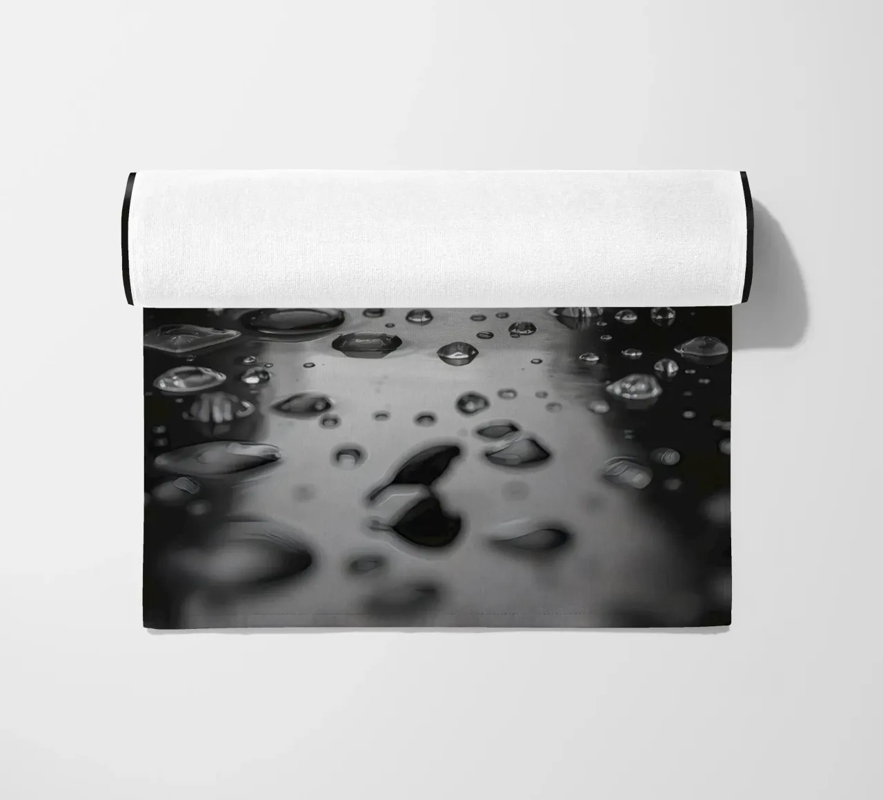 Raindrops creating reflections on a wet surface beach towel by DesignDoodle