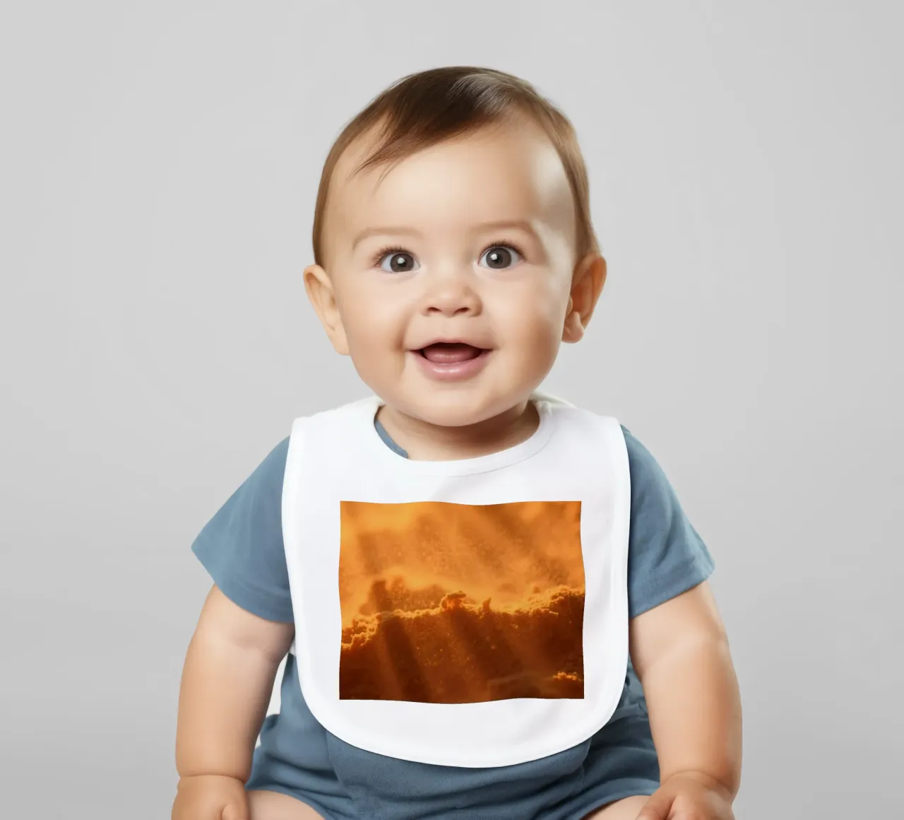 Sandy texture illuminated by soft light creating a warm feel baby bib by DesignDoodle