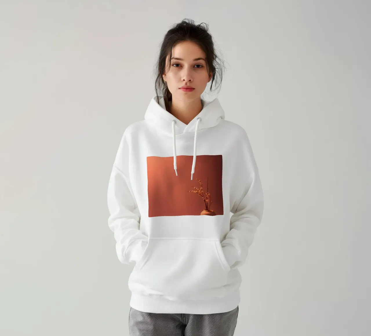 Elegant vase with delicate flowers against a warm background hoodie by DesignDoodle
