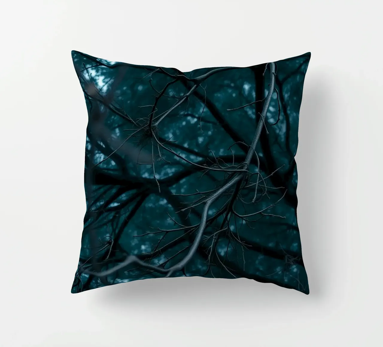 Branches intertwine against a dark, moody backdrop decorative cushion by DesignDoodle