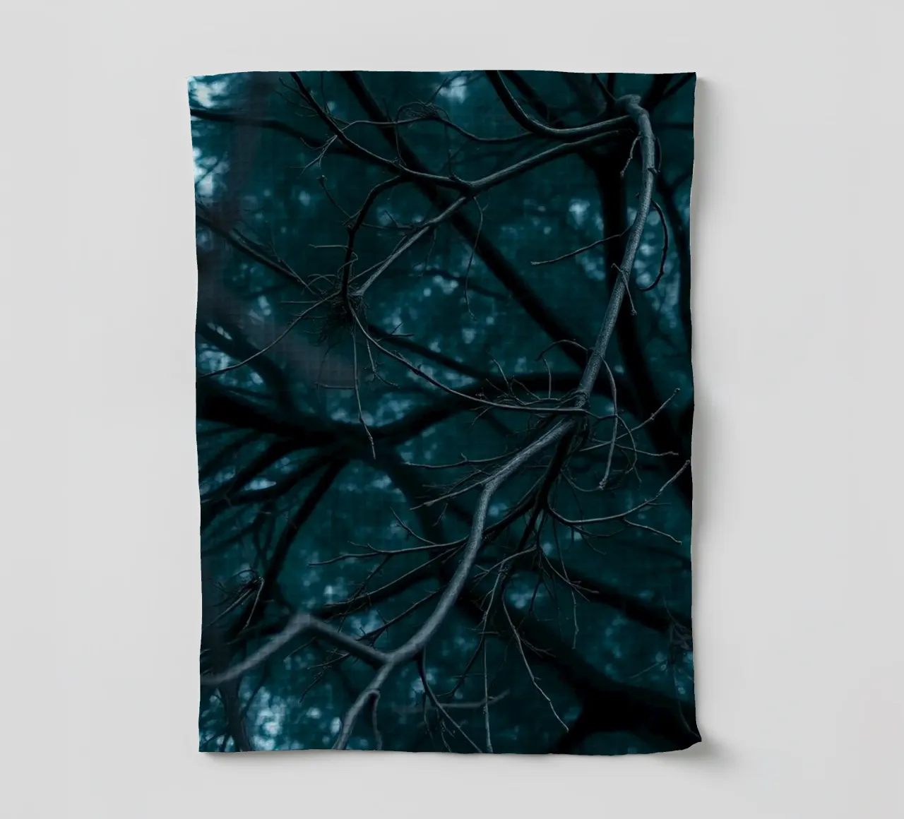 Branches intertwine against a dark, moody backdrop tea towel by DesignDoodle