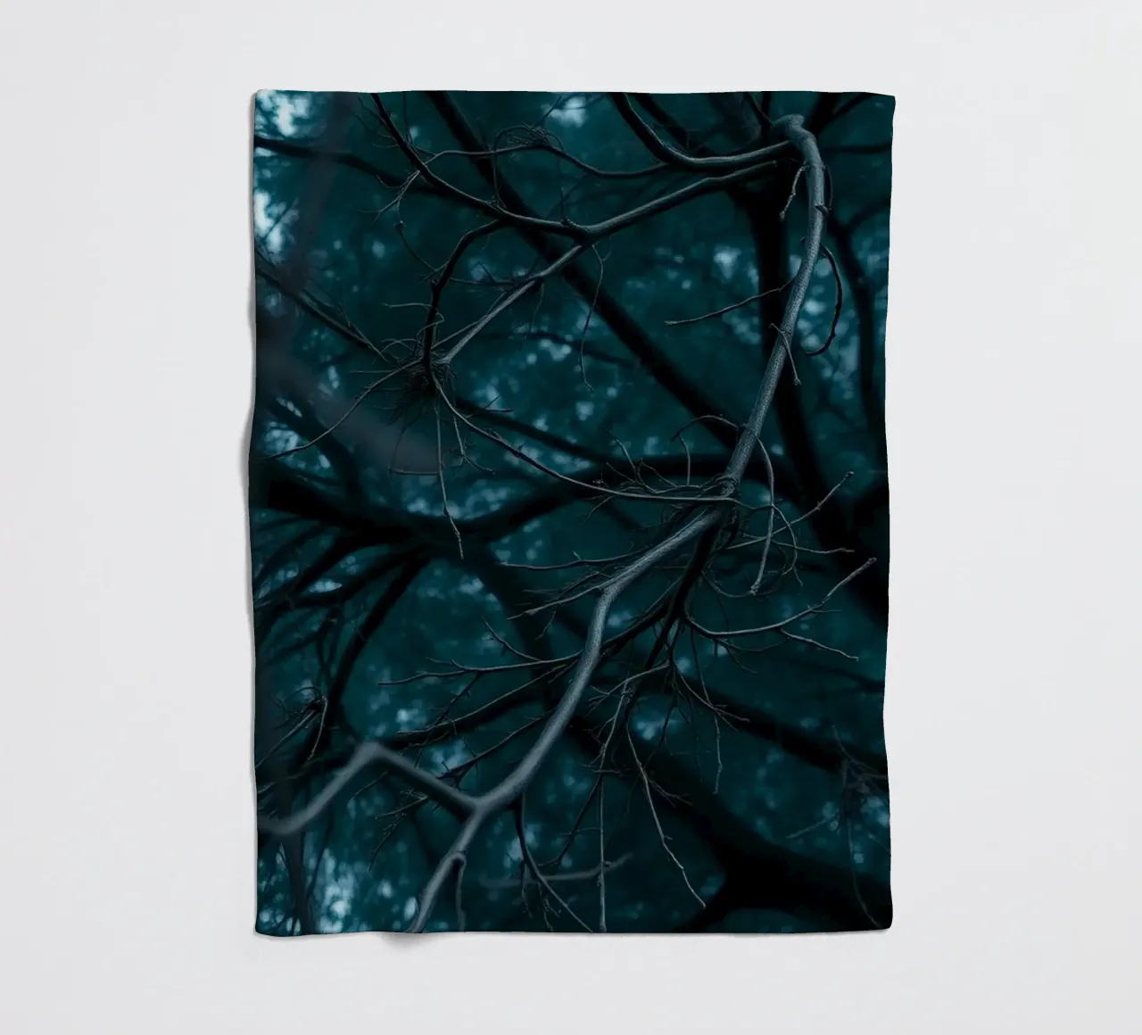 Branches intertwine against a dark, moody backdrop fleece blanket by DesignDoodle