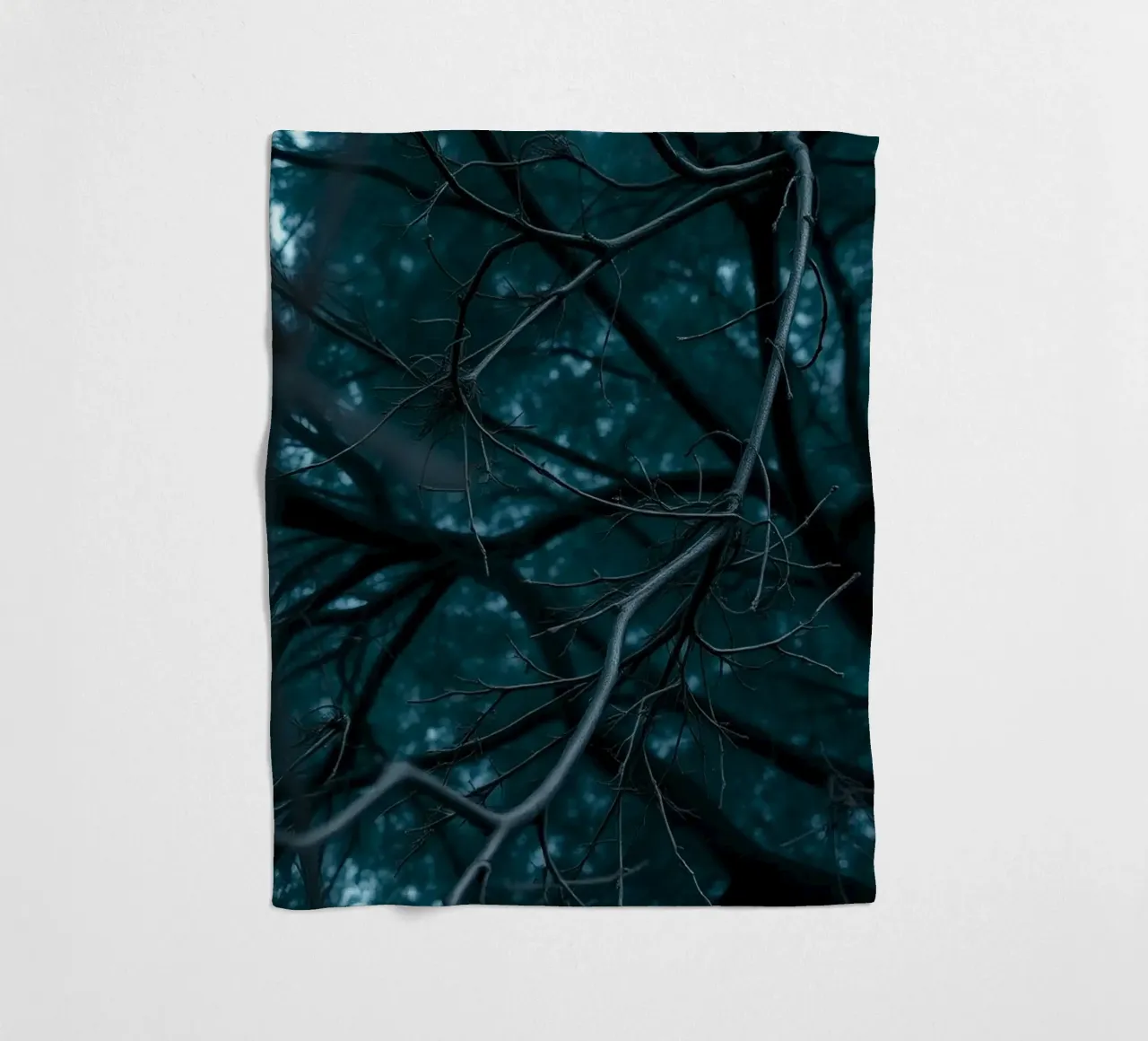 Branches intertwine against a dark, moody backdrop fleece blanket by DesignDoodle