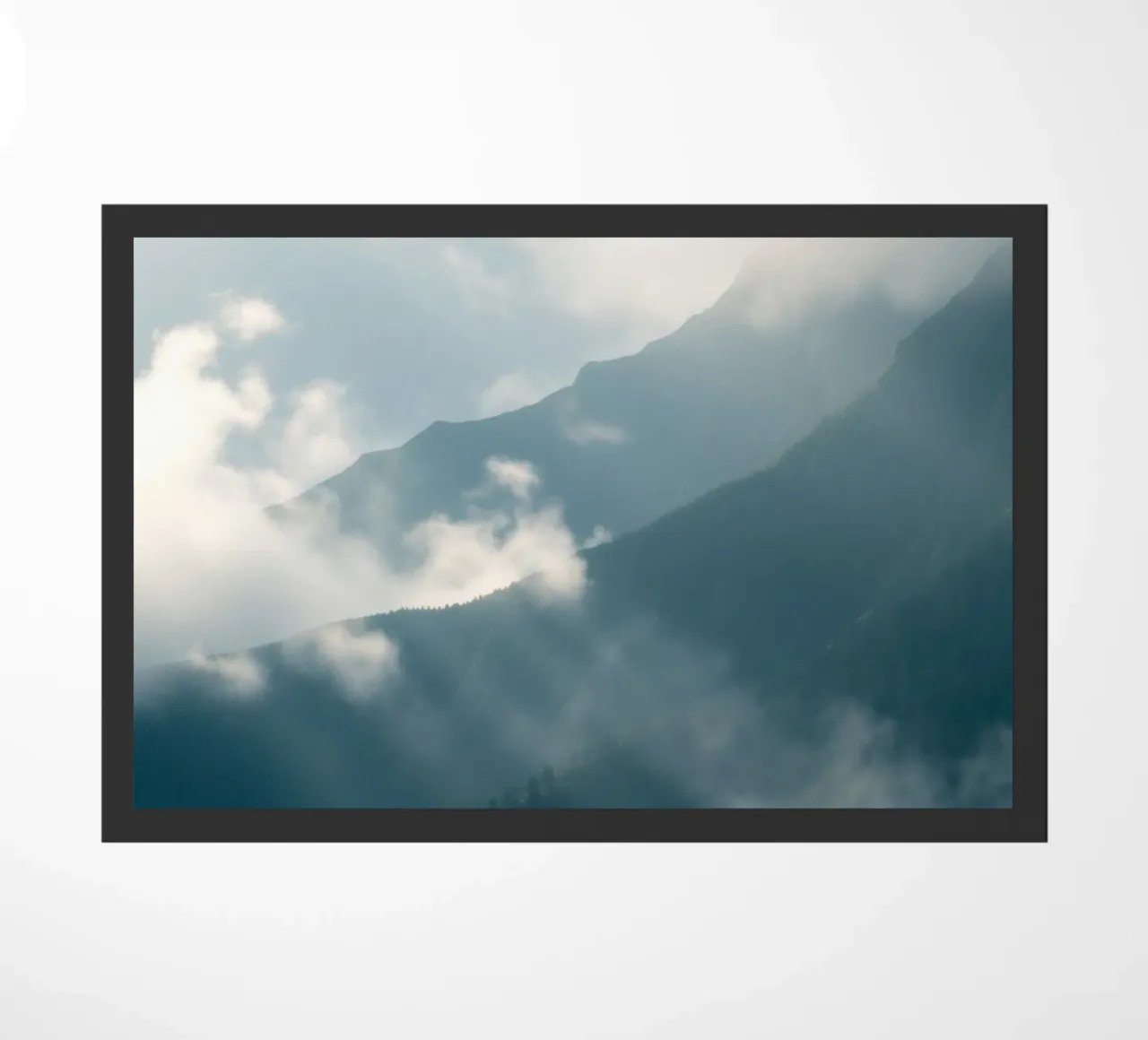 Mountain landscape with mist and clouds creating a serene doormat by DesignDoodle