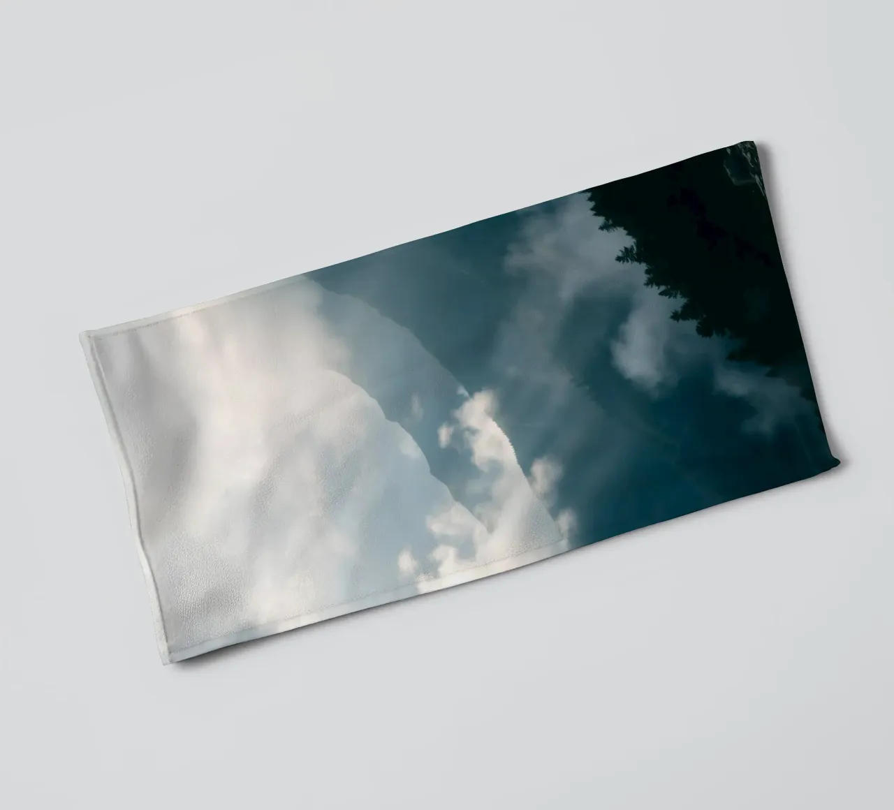 Mountain landscape with mist and clouds creating a serene towel by DesignDoodle