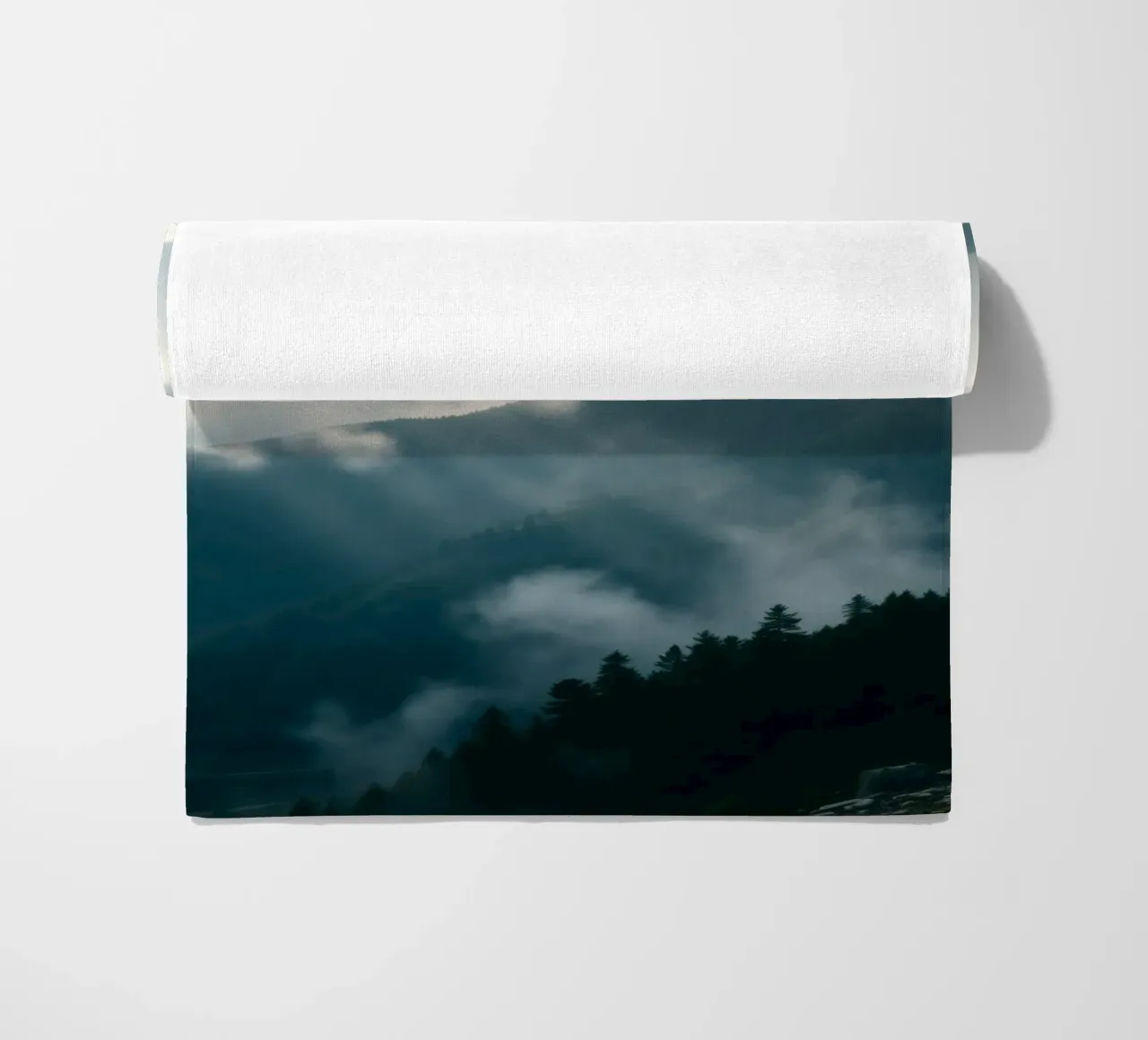 Mountain landscape with mist and clouds creating a serene beach towel by DesignDoodle