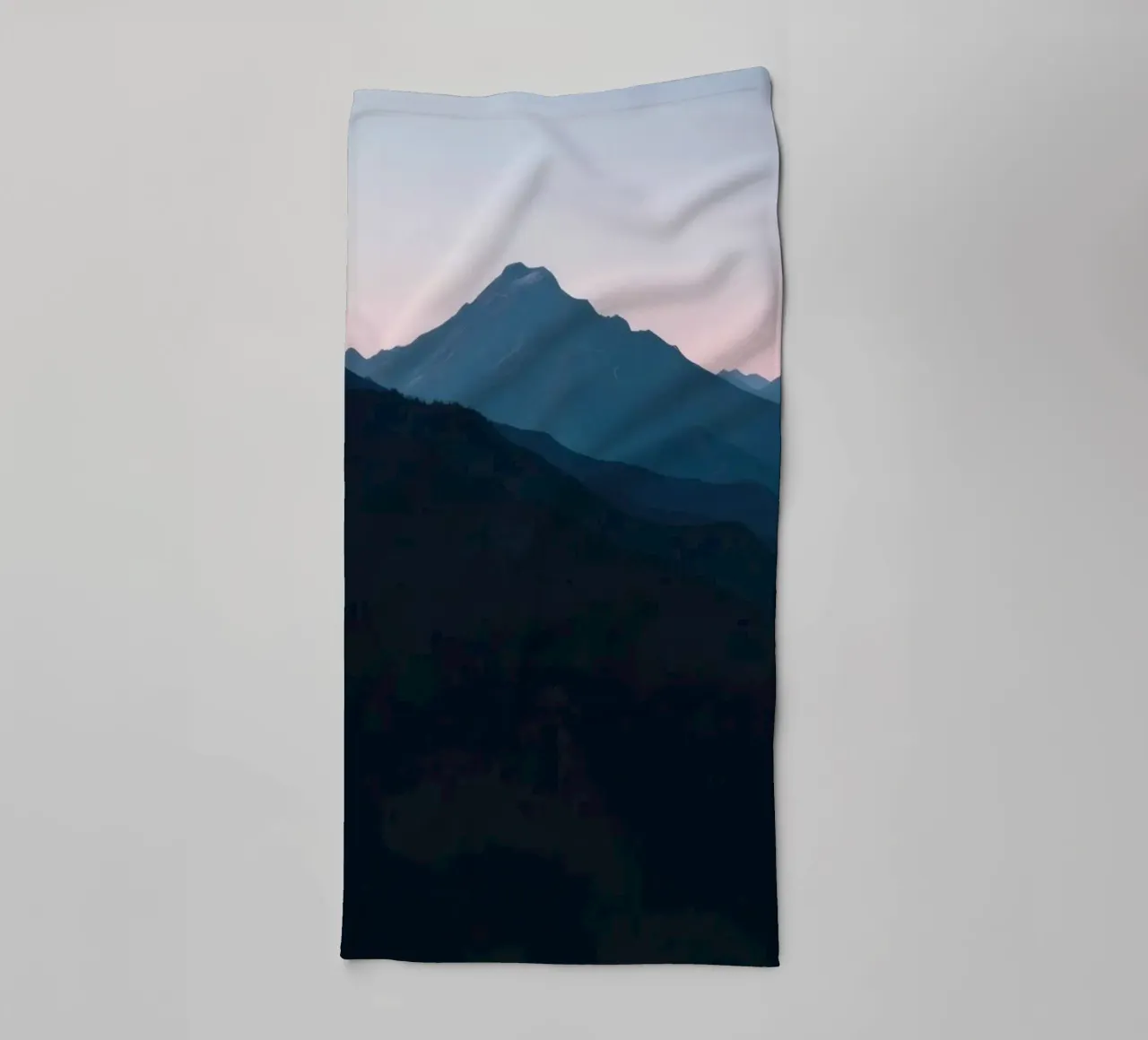 Serene mountain silhouettes at dusk create a tranquil feel towel by DesignDoodle