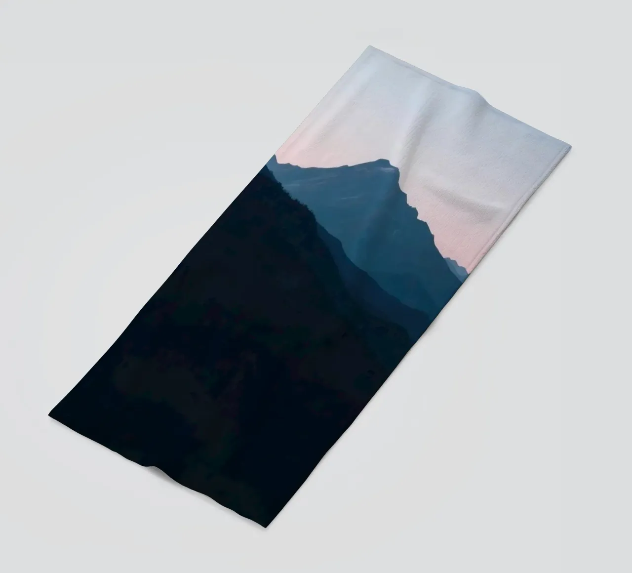 Serene mountain silhouettes at dusk create a tranquil feel beach towel by DesignDoodle