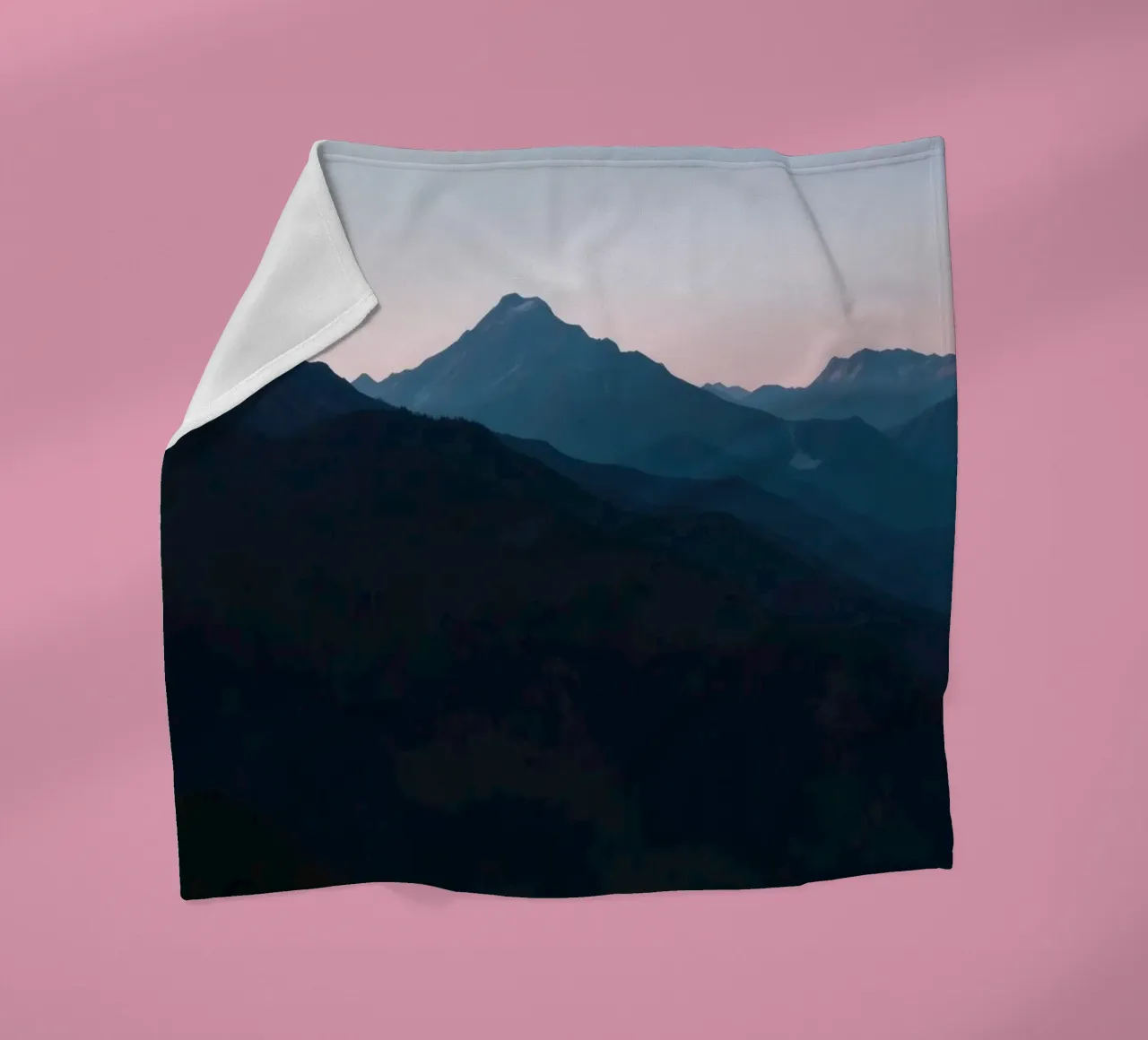 Serene mountain silhouettes at dusk create a tranquil feel fleece blanket by DesignDoodle