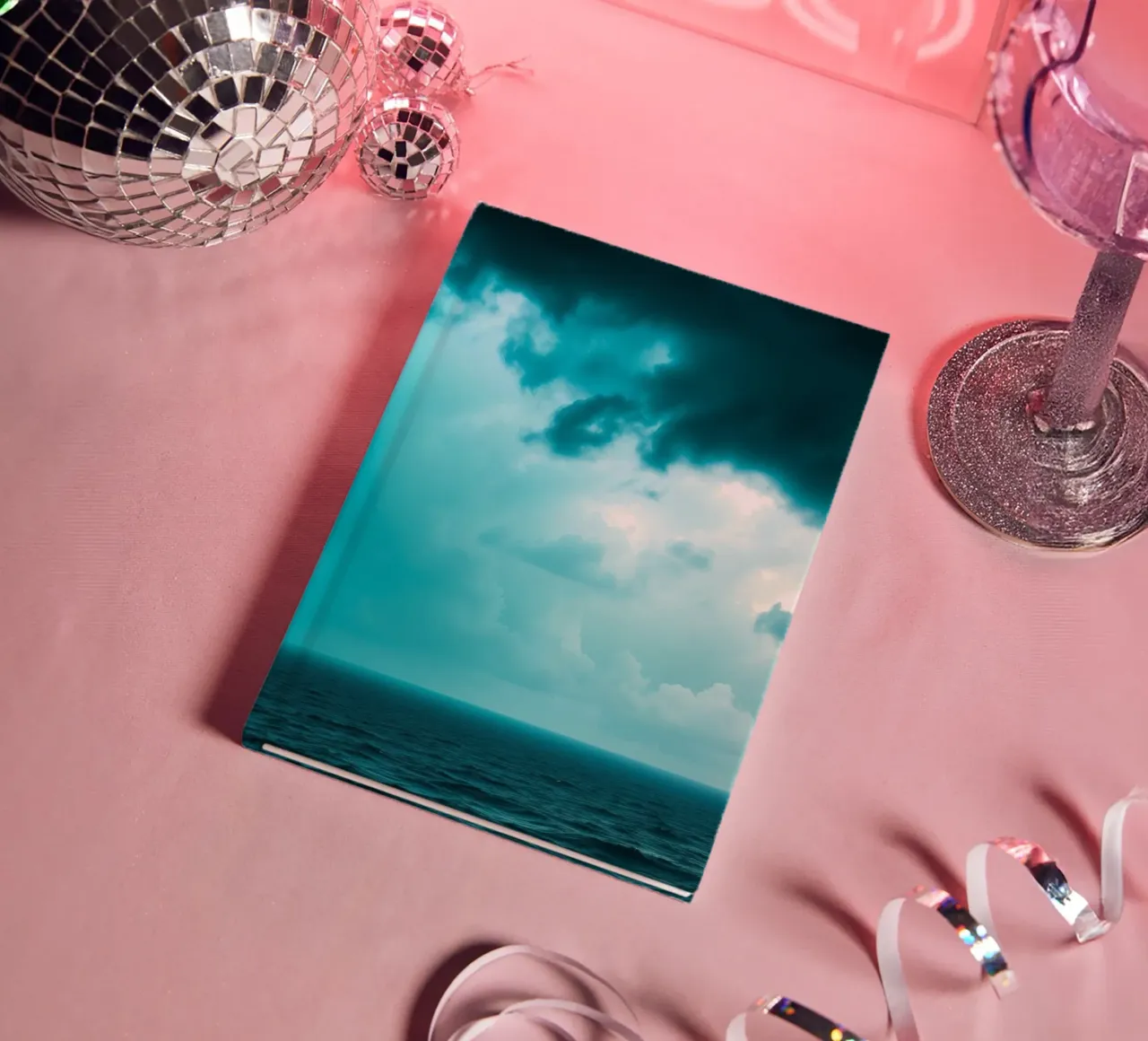 Dynamic sky over calm ocean creates serene backdrop for mobi notebook by DesignDoodle