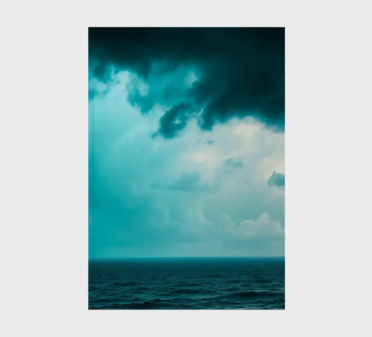 Dynamic sky over calm ocean creates serene backdrop for mobi notebook by DesignDoodle