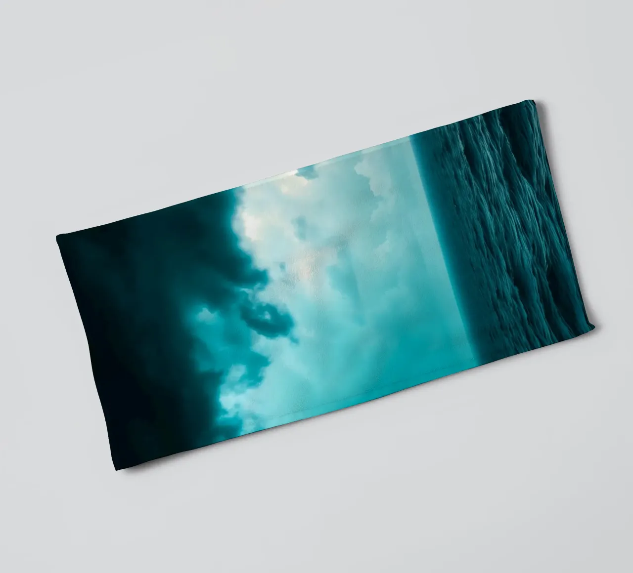 Dynamic sky over calm ocean creates serene backdrop for mobi towel by DesignDoodle