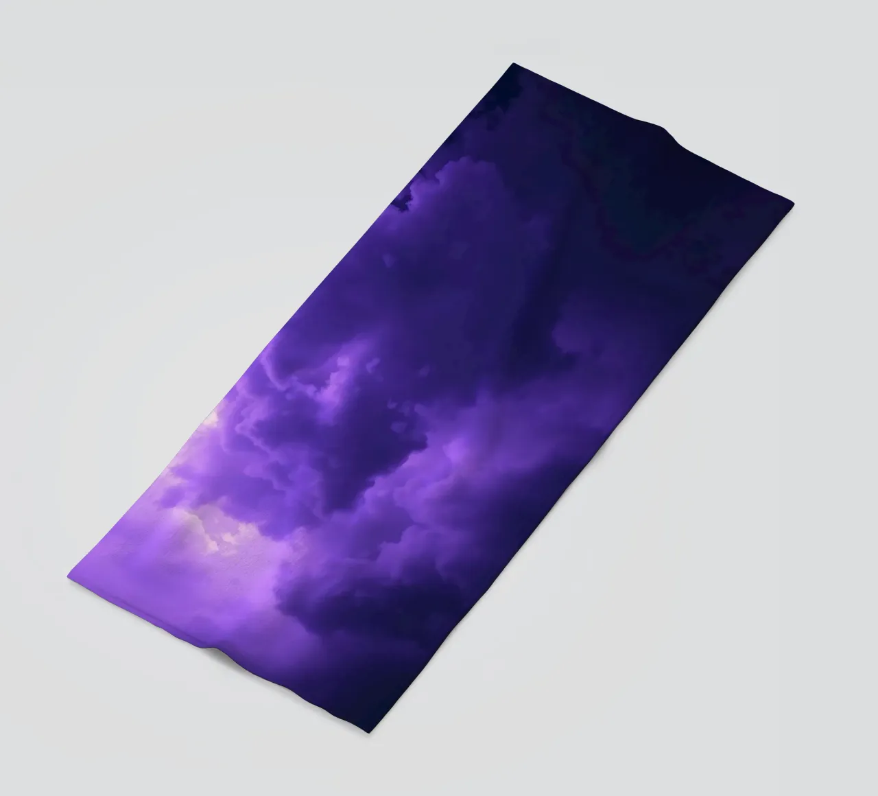 purple clouds filling the sky create a captivating art beach towel by DesignDoodle