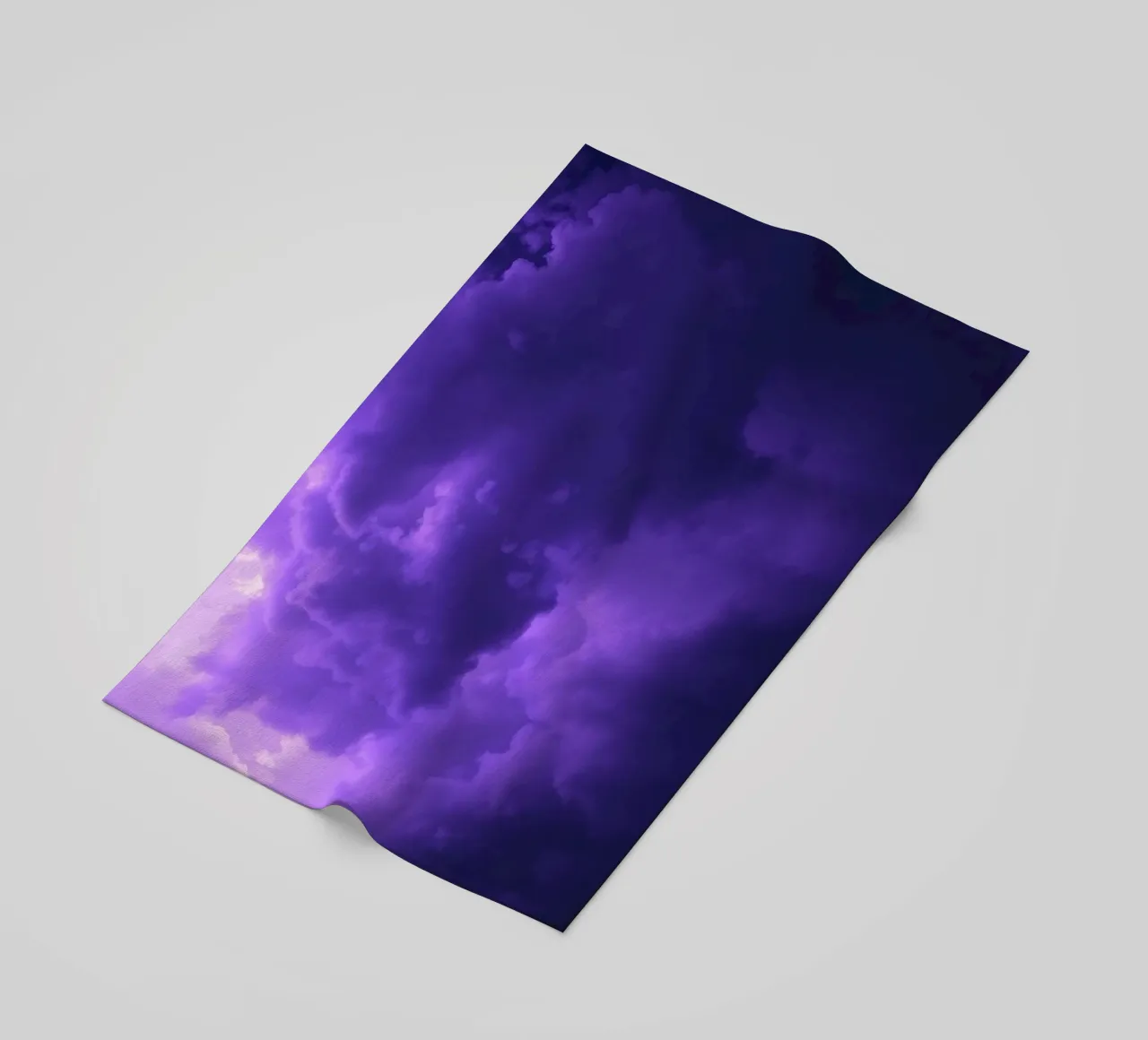 purple clouds filling the sky create a captivating art beach towel by DesignDoodle