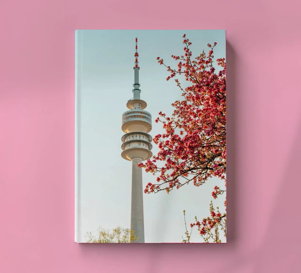 Munich television tower in spring with blossoming tree notebook by Bold and Retro