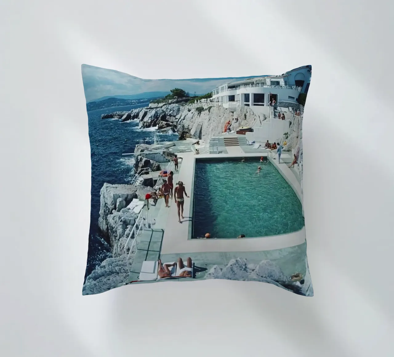Sunbathing at the Beachside Pool Antibes, 1976 - Slim Aarons decorative cushion by The Poster UK