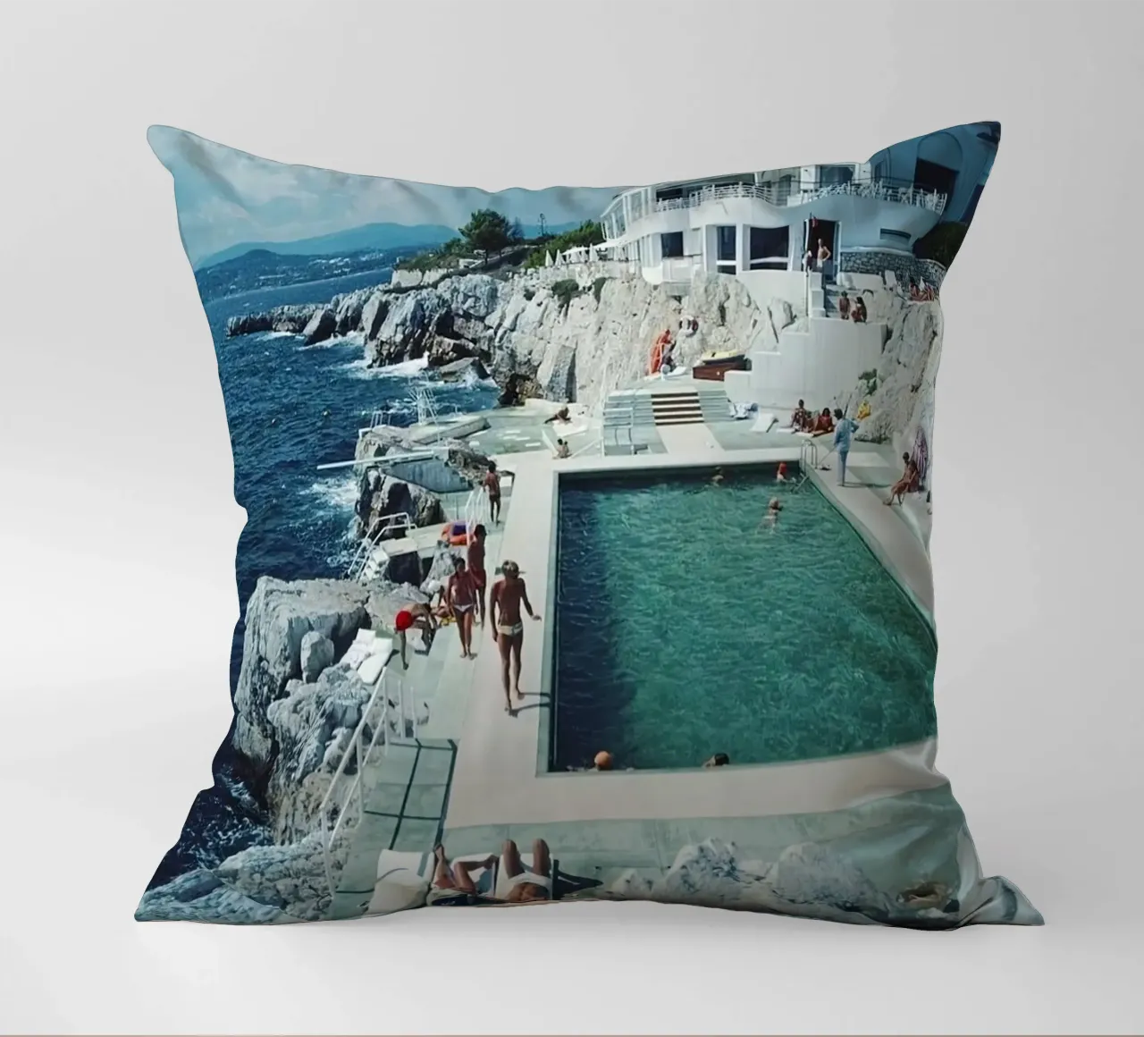 Sunbathing at the Beachside Pool Antibes, 1976 - Slim Aarons decorative cushion by The Poster UK