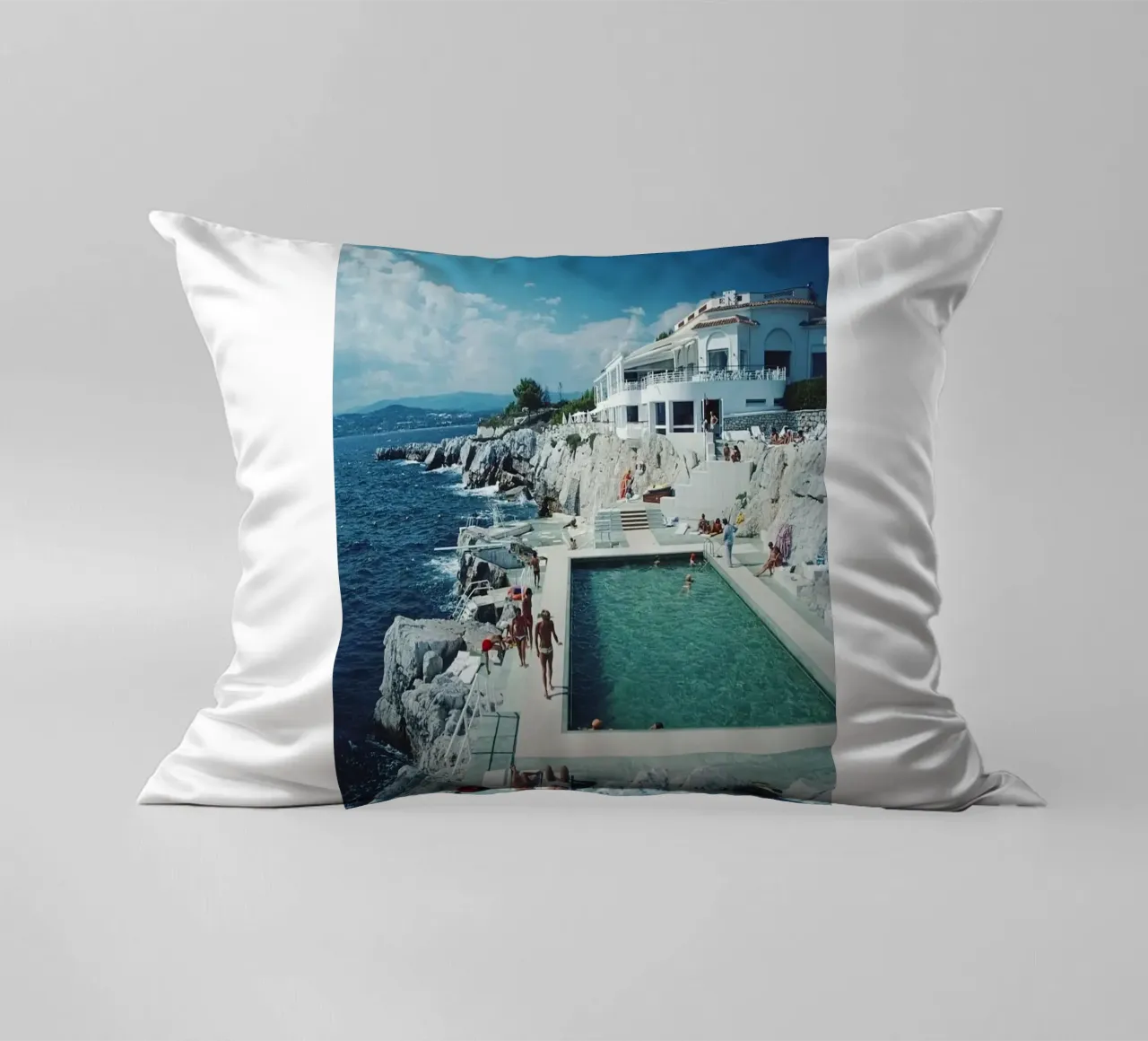 Sunbathing at the Beachside Pool Antibes, 1976 - Slim Aarons decorative cushion by The Poster UK