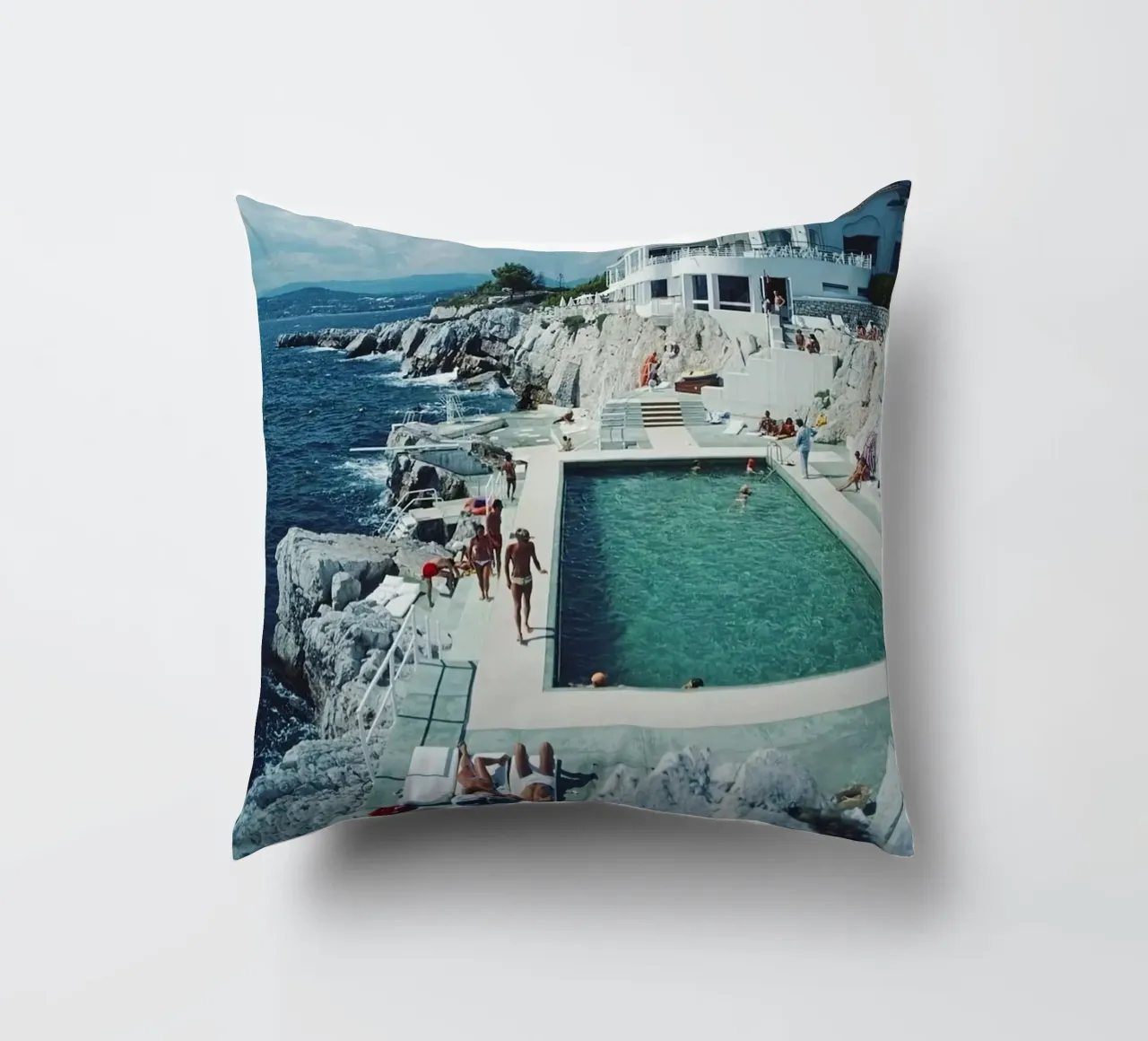 Sunbathing at the Beachside Pool Antibes, 1976 - Slim Aarons decorative cushion by The Poster UK