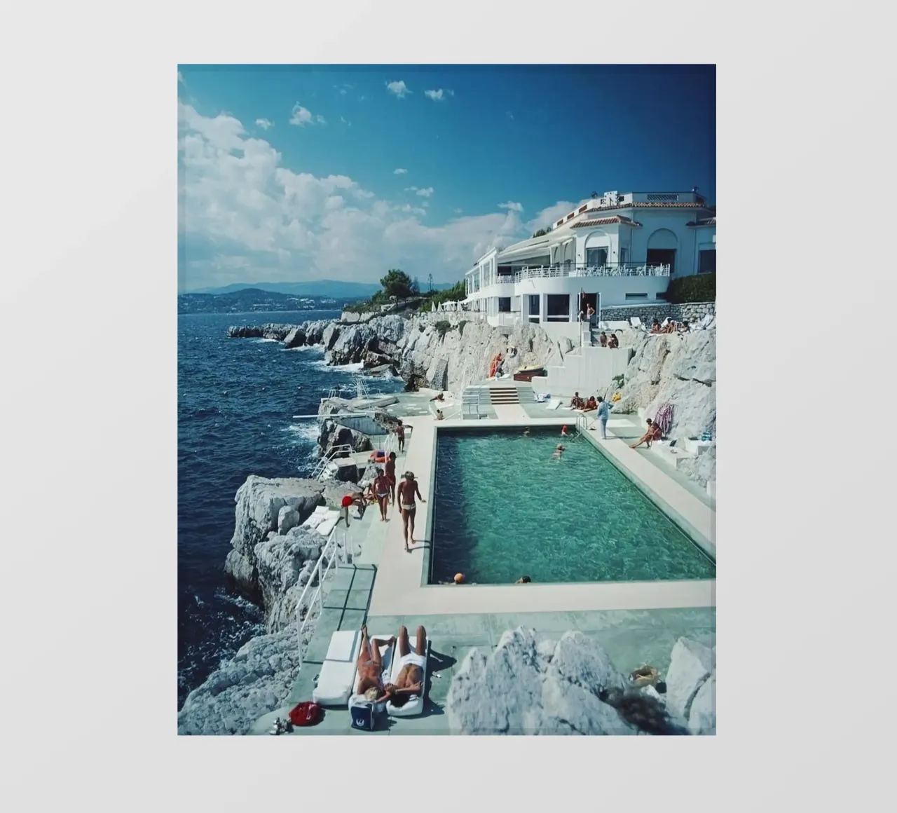 Sunbathing at the Beachside Pool Antibes, 1976 - Slim Aarons pvc cover by The Poster UK