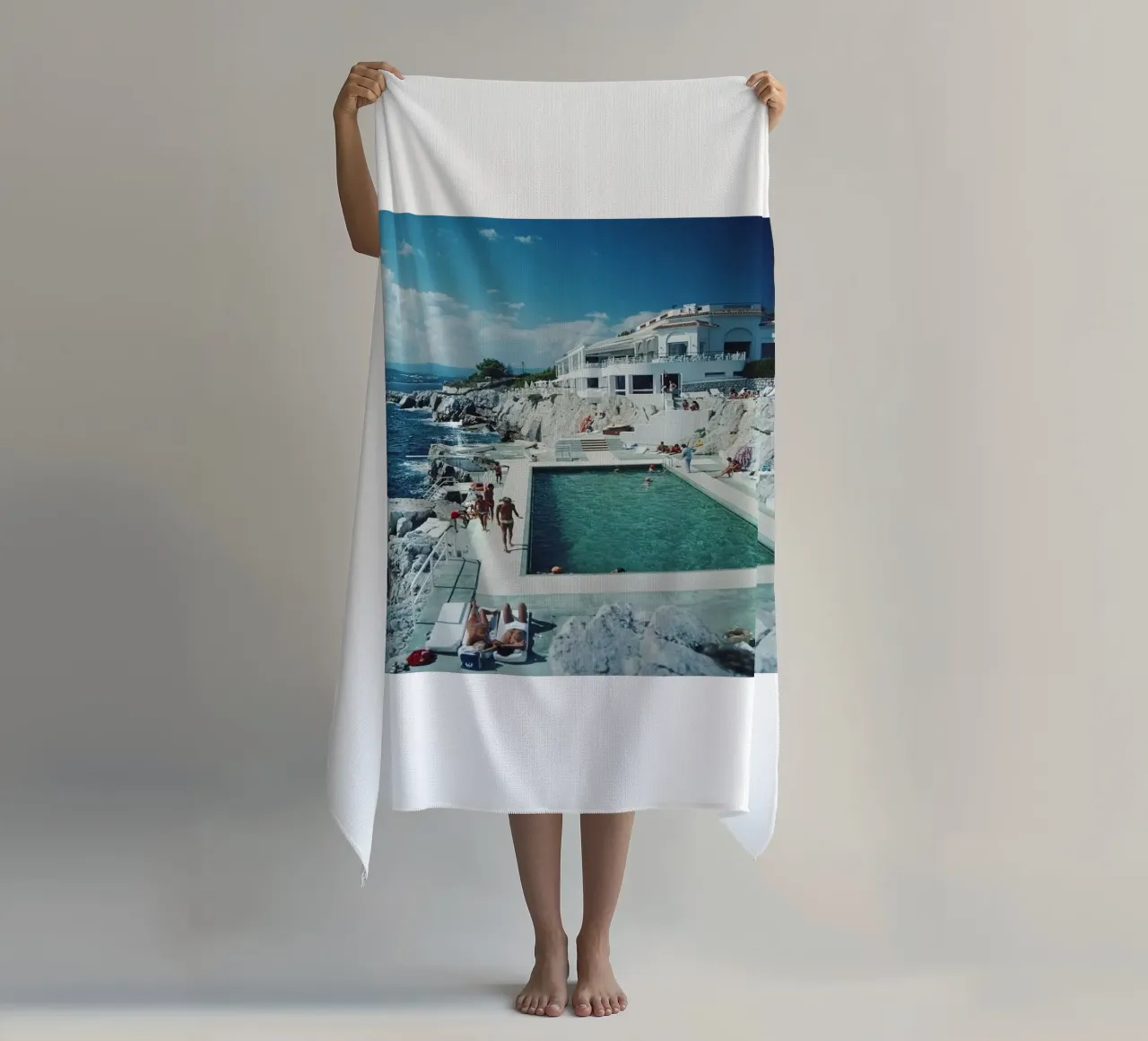 Sunbathing at the Beachside Pool Antibes, 1976 - Slim Aarons beach towel by The Poster UK