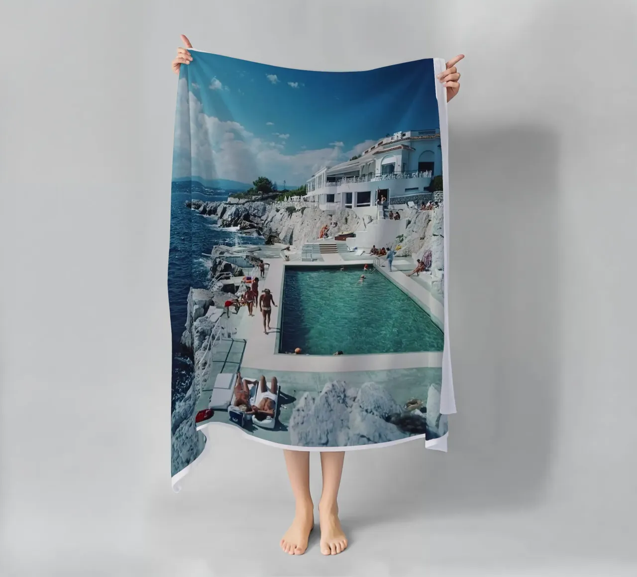 Sunbathing at the Beachside Pool Antibes, 1976 - Slim Aarons beach towel by The Poster UK