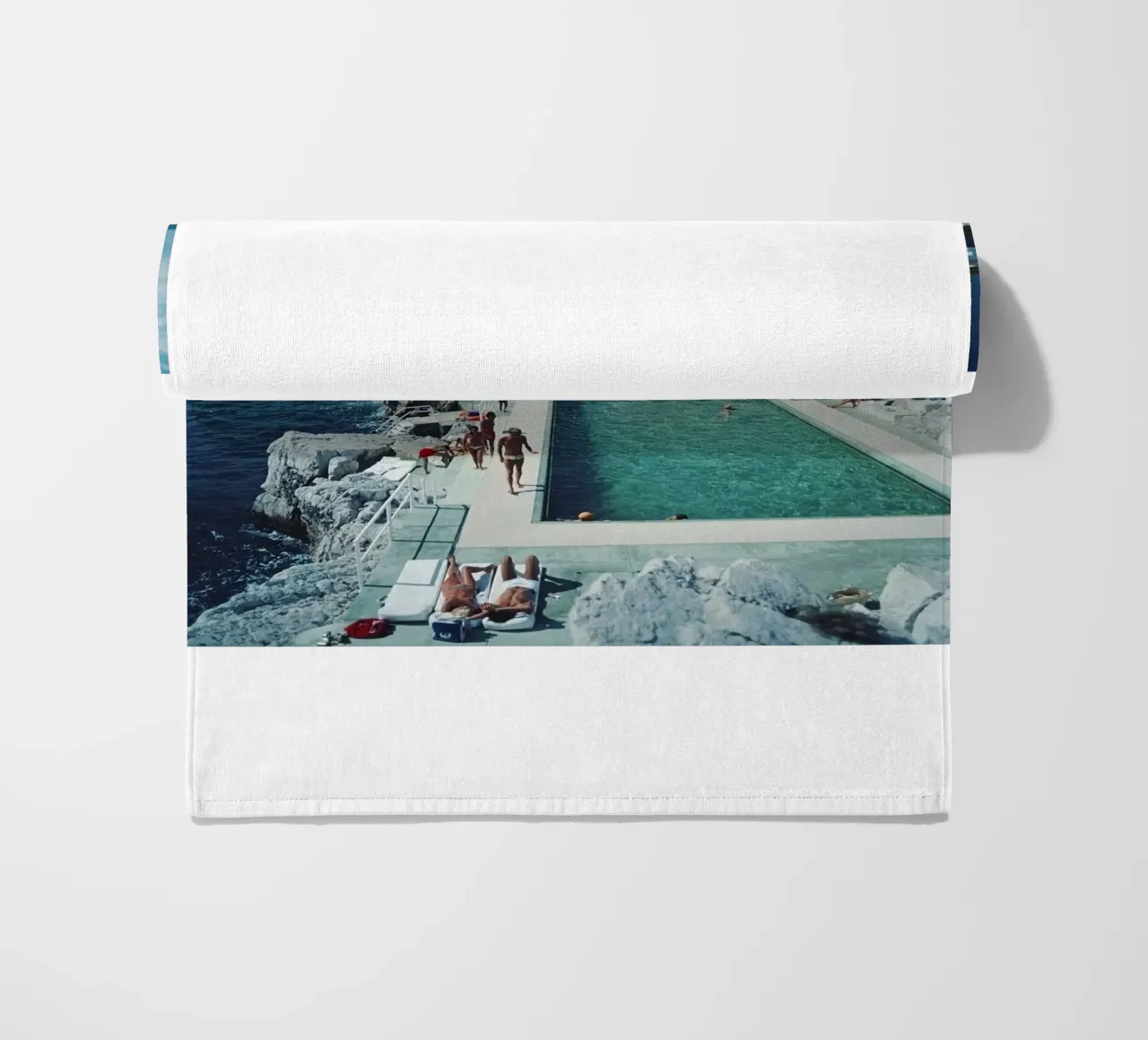 Sunbathing at the Beachside Pool Antibes, 1976 - Slim Aarons beach towel by The Poster UK