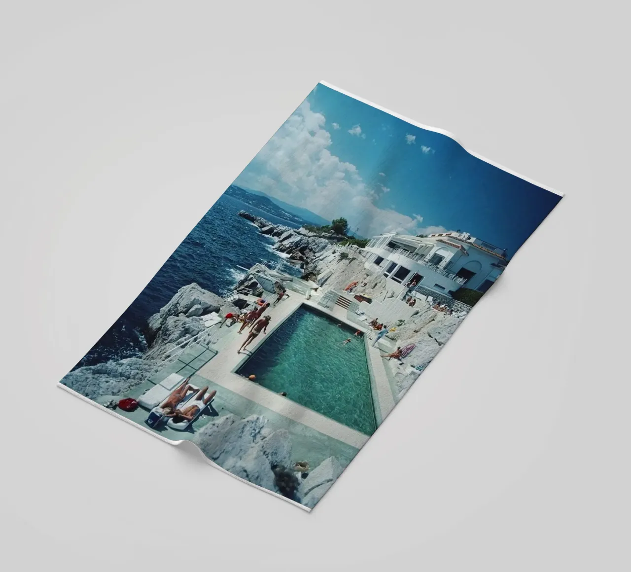 Sunbathing at the Beachside Pool Antibes, 1976 - Slim Aarons beach towel by The Poster UK