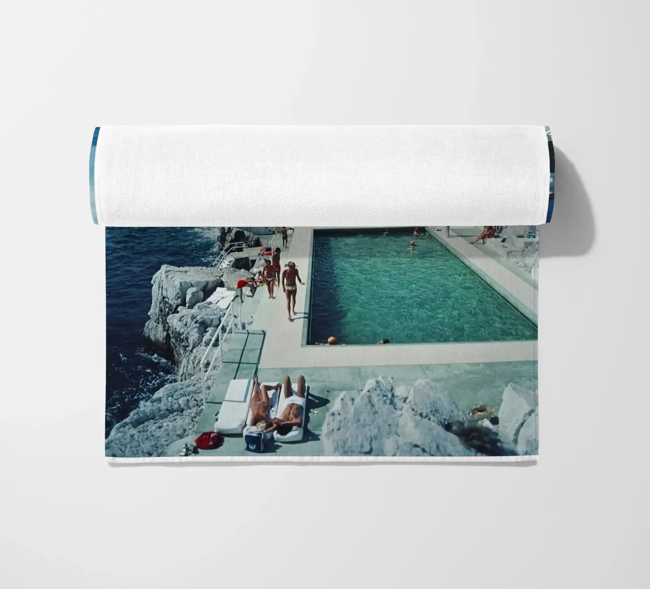 Sunbathing at the Beachside Pool Antibes, 1976 - Slim Aarons beach towel by The Poster UK