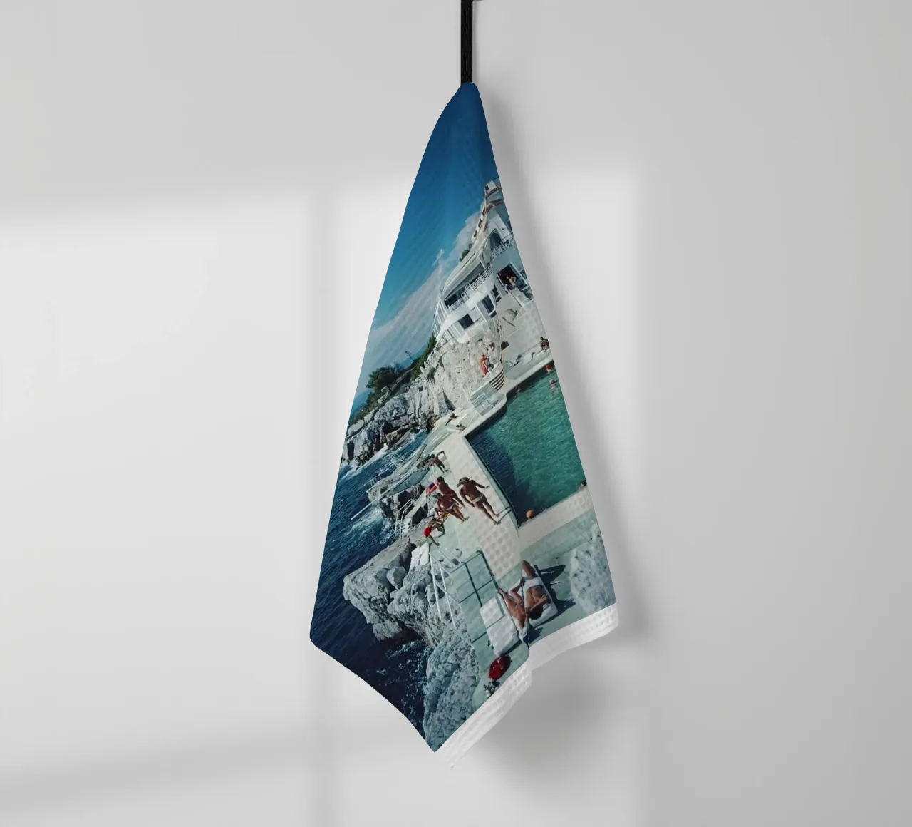Sunbathing at the Beachside Pool Antibes, 1976 - Slim Aarons tea towel by The Poster UK