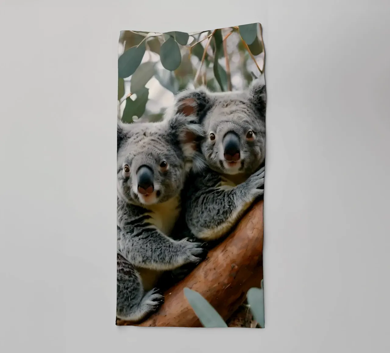 Two koalas resting together on a eucalyptus tree towel by DesignDoodle