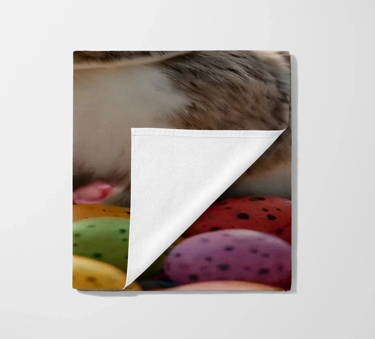 Rabbits exploring a colorful array of eggs beach towel by DesignDoodle