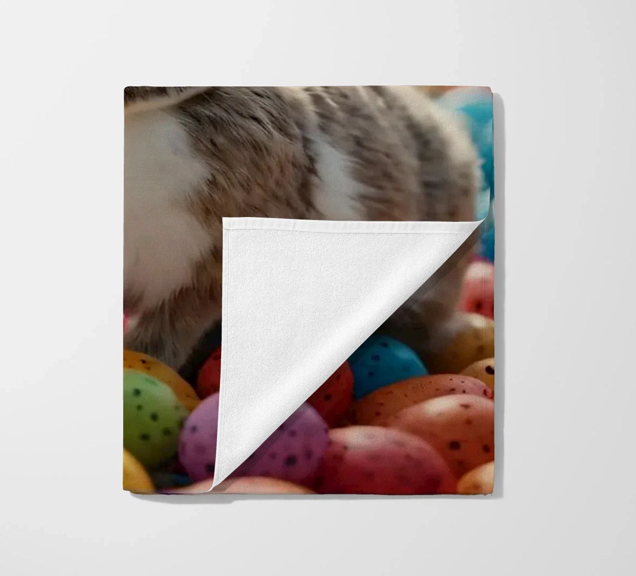Rabbits exploring a colorful array of eggs beach towel by DesignDoodle