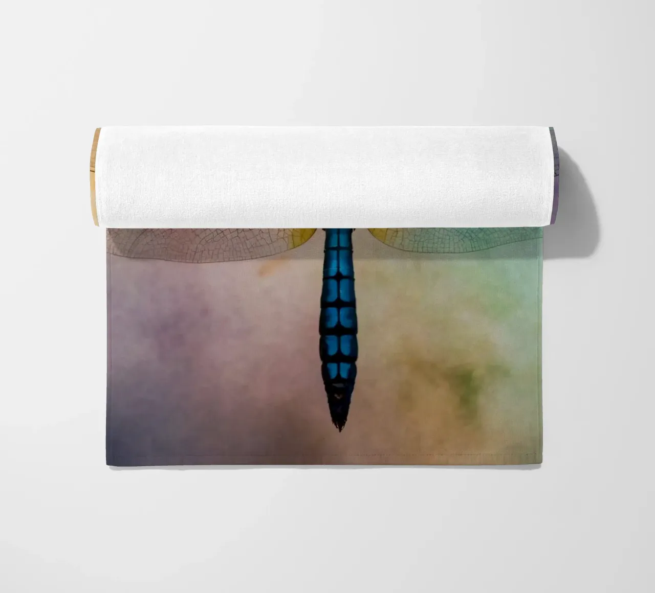 Colorful dragonfly hovering against a vibrant, abstract back beach towel by DesignDoodle
