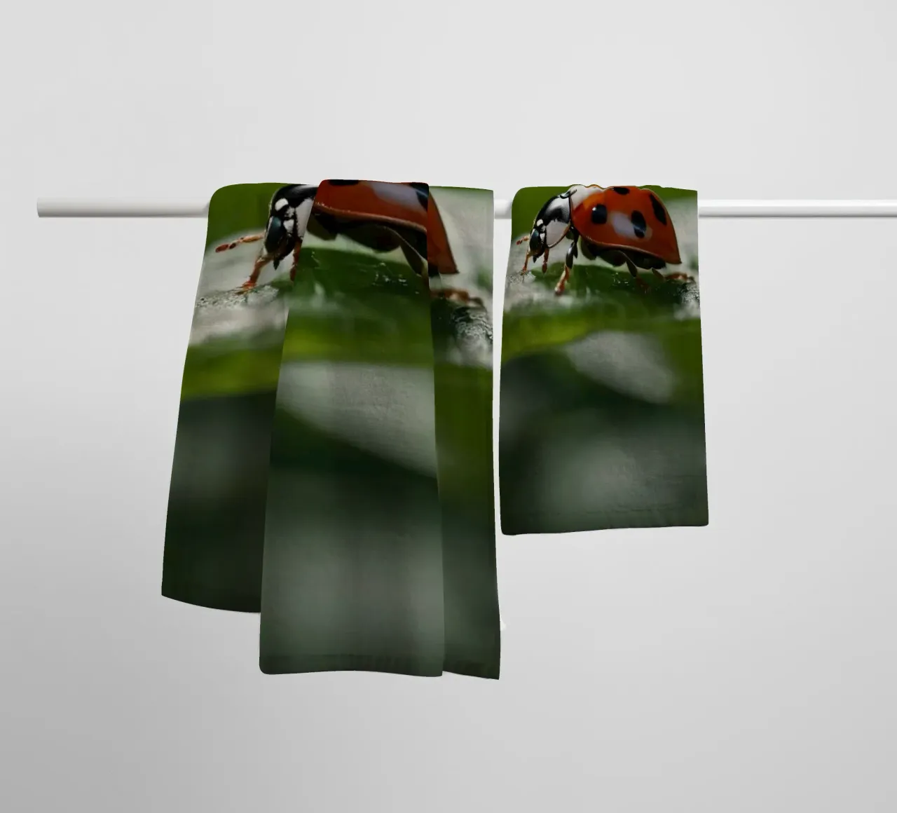 Ladybug crawling on a green leaf adorned with water droplets towel by DesignDoodle