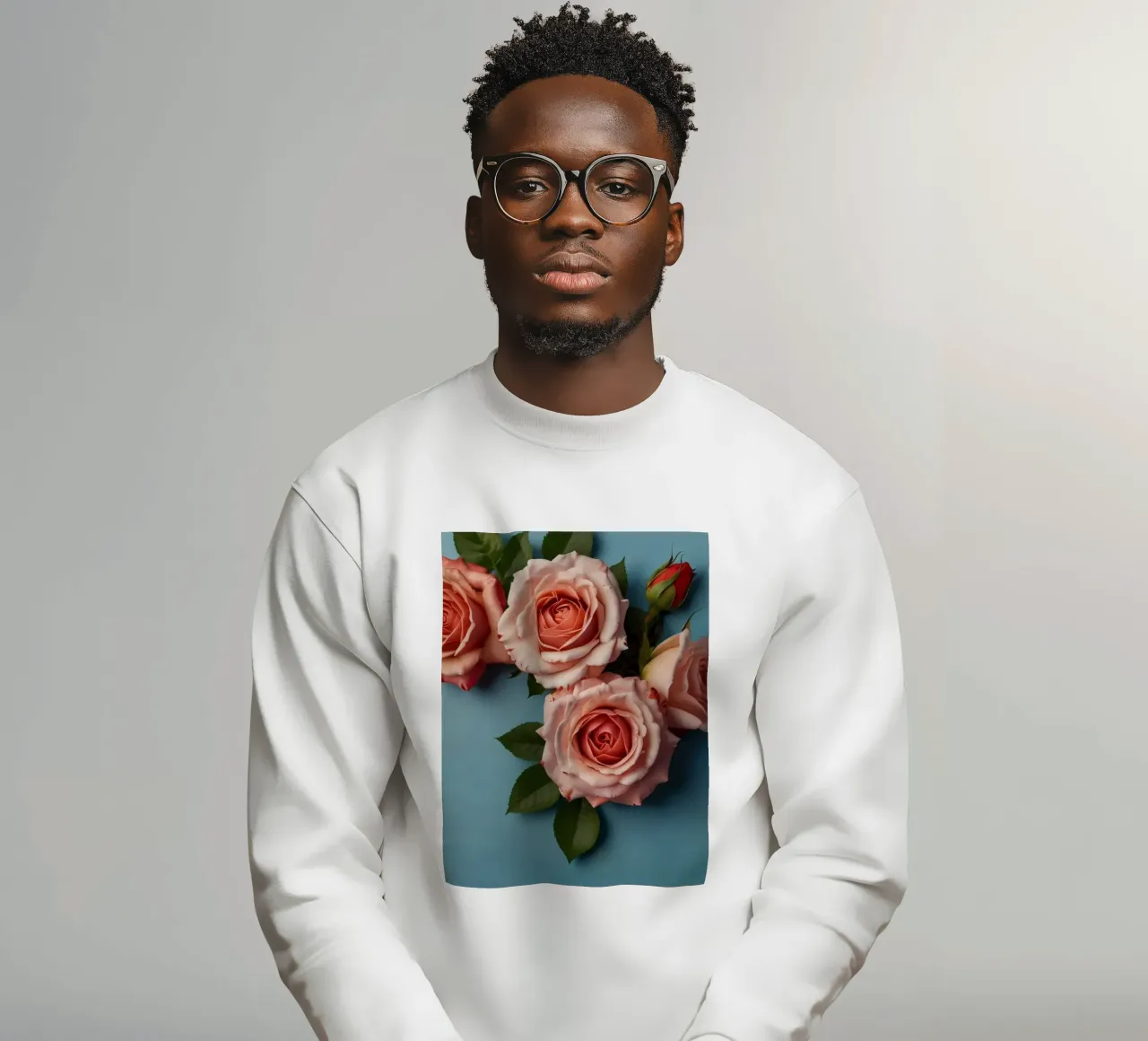 Beautiful pink roses set against a blue background sweatshirt by DesignDoodle