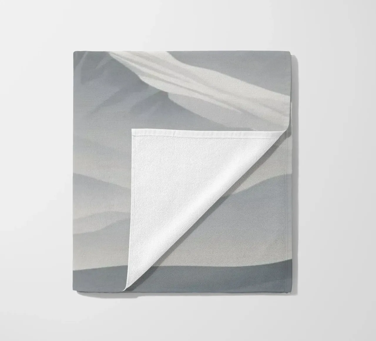 mountain range with snow-capped peaks and cloudy skies beach towel by DesignDoodle
