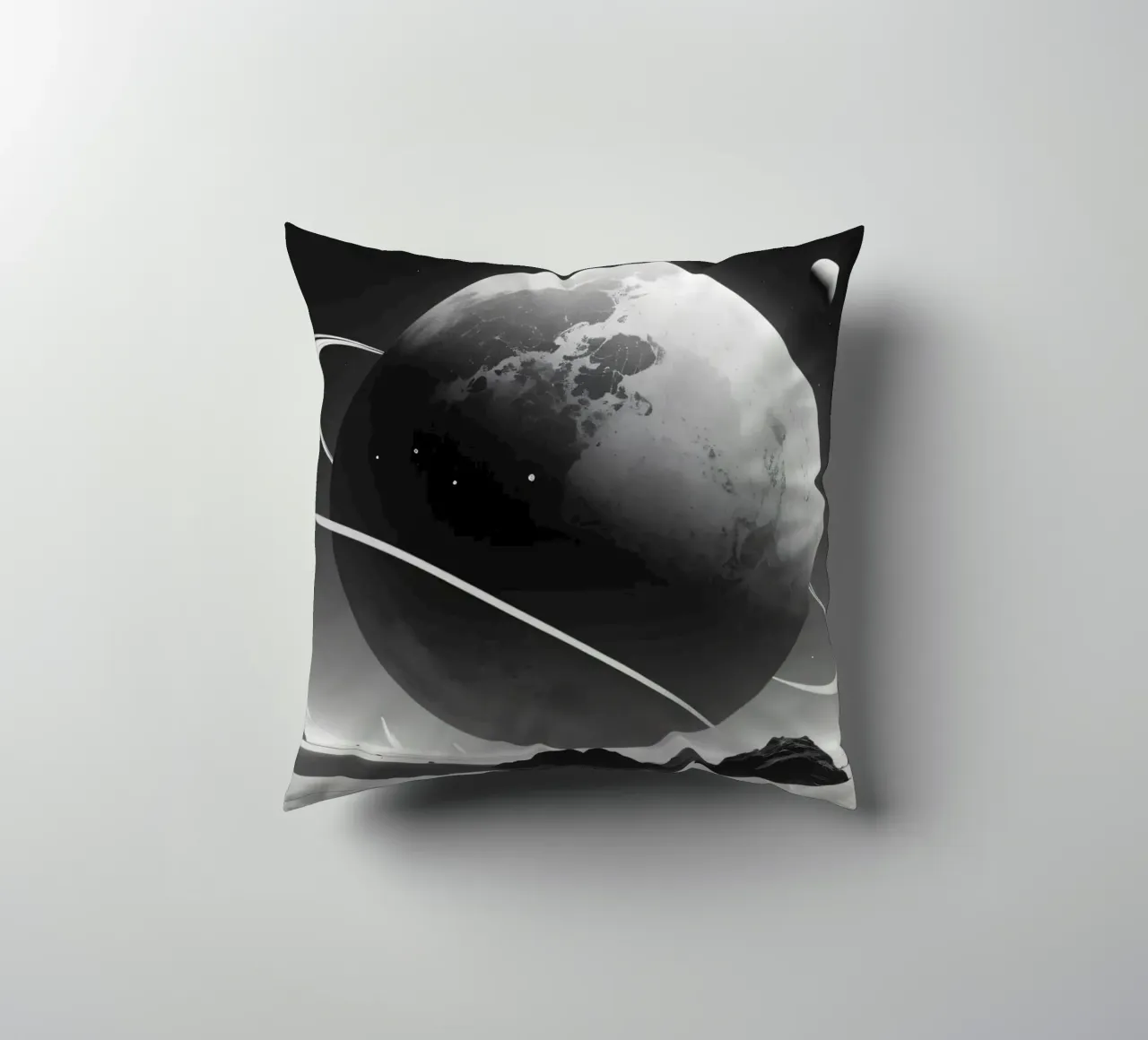 planet with rings hovering over a desolate landscape under a decorative cushion by DesignDoodle