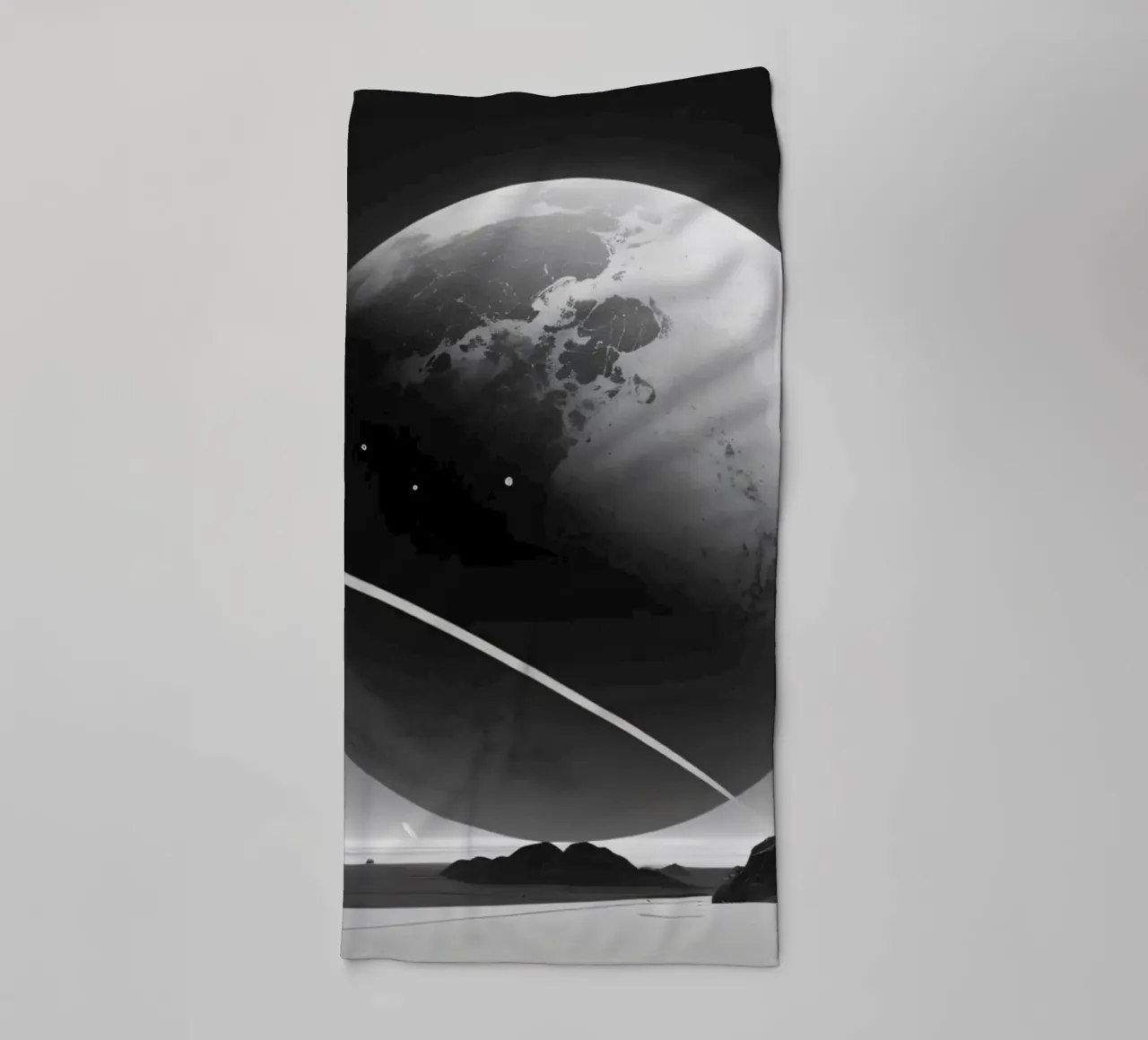 planet with rings hovering over a desolate landscape under a towel by DesignDoodle