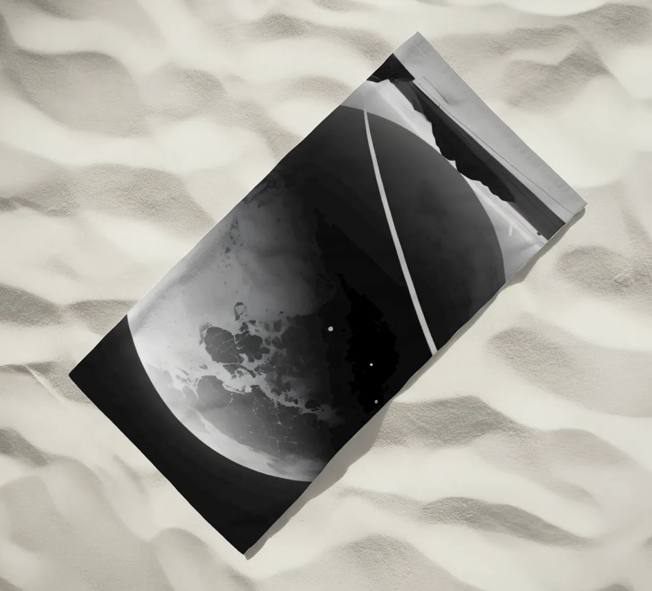 planet with rings hovering over a desolate landscape under a beach towel by DesignDoodle