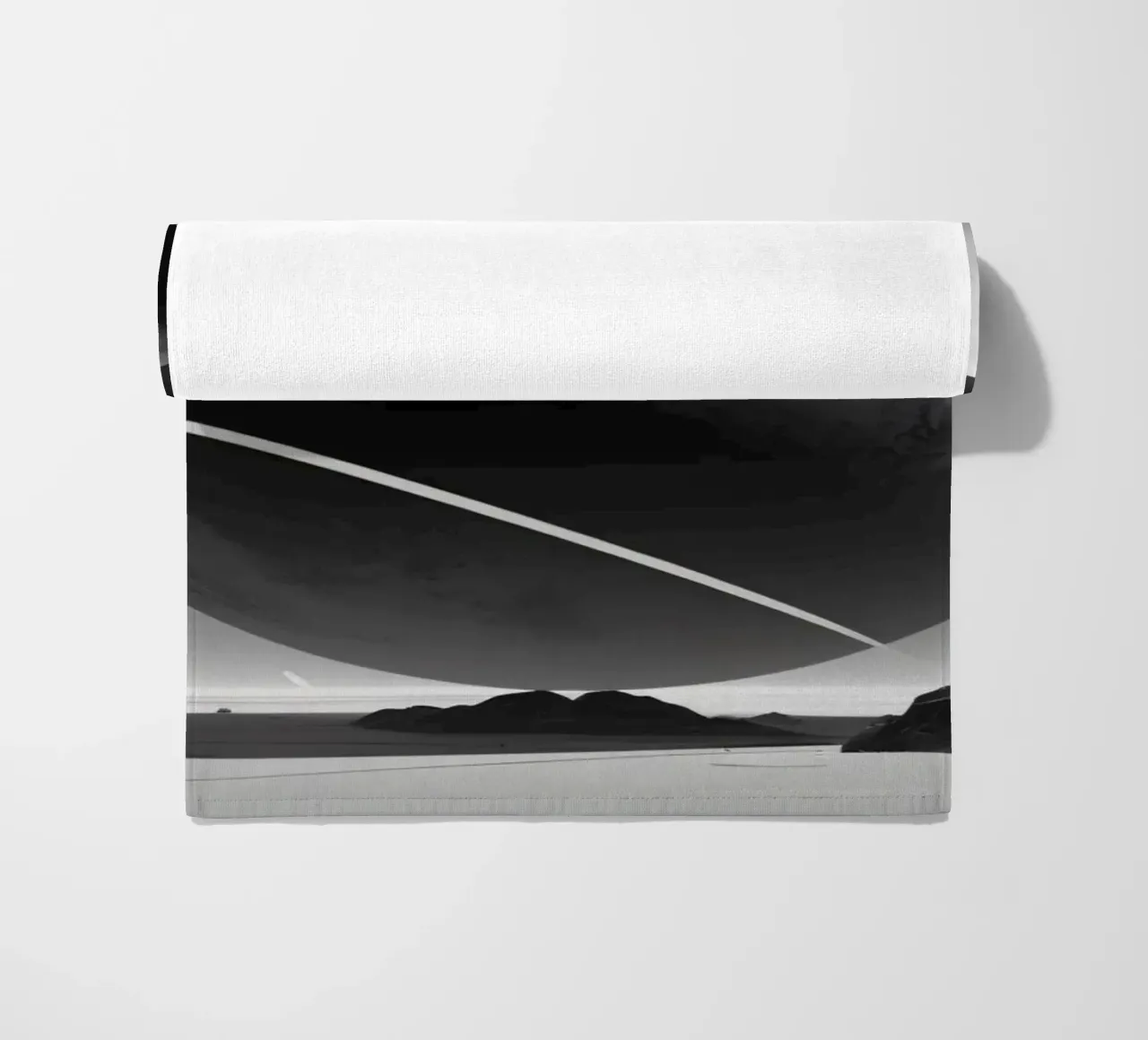 planet with rings hovering over a desolate landscape under a beach towel by DesignDoodle