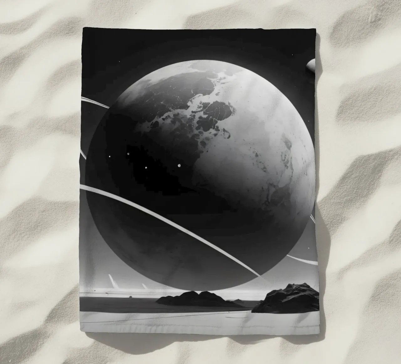 planet with rings hovering over a desolate landscape under a beach towel by DesignDoodle