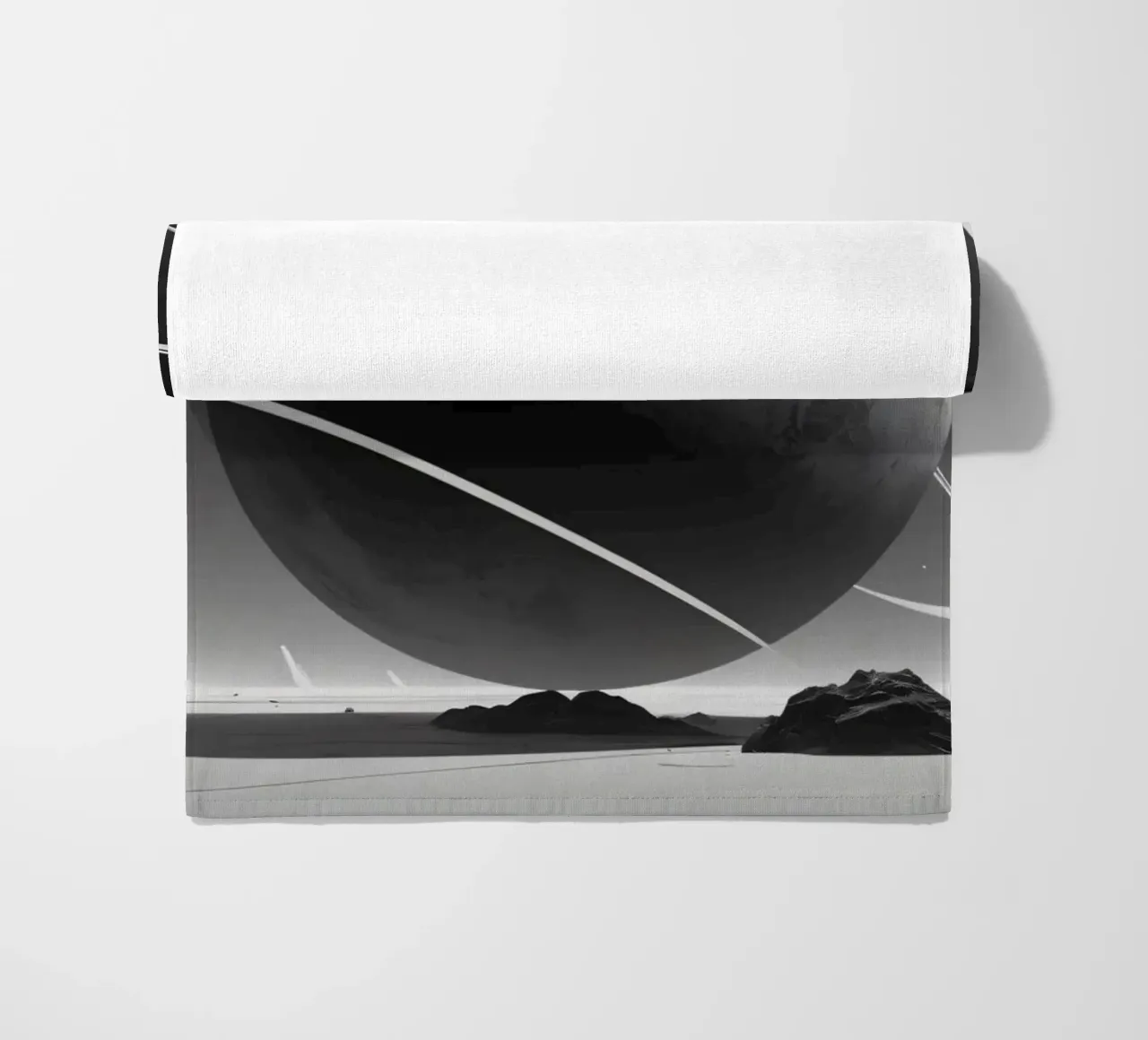 planet with rings hovering over a desolate landscape under a beach towel by DesignDoodle