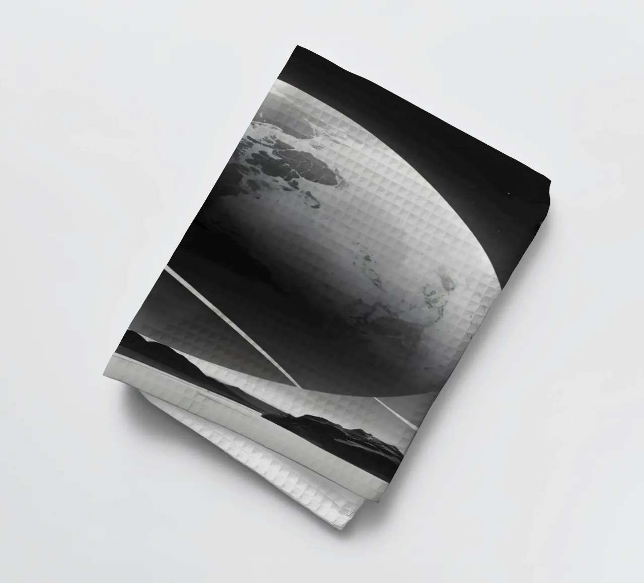 Planet mit Ringen, der über einer trostlosen Landschaft unter einer Geschirrtuch von DesignDoodle