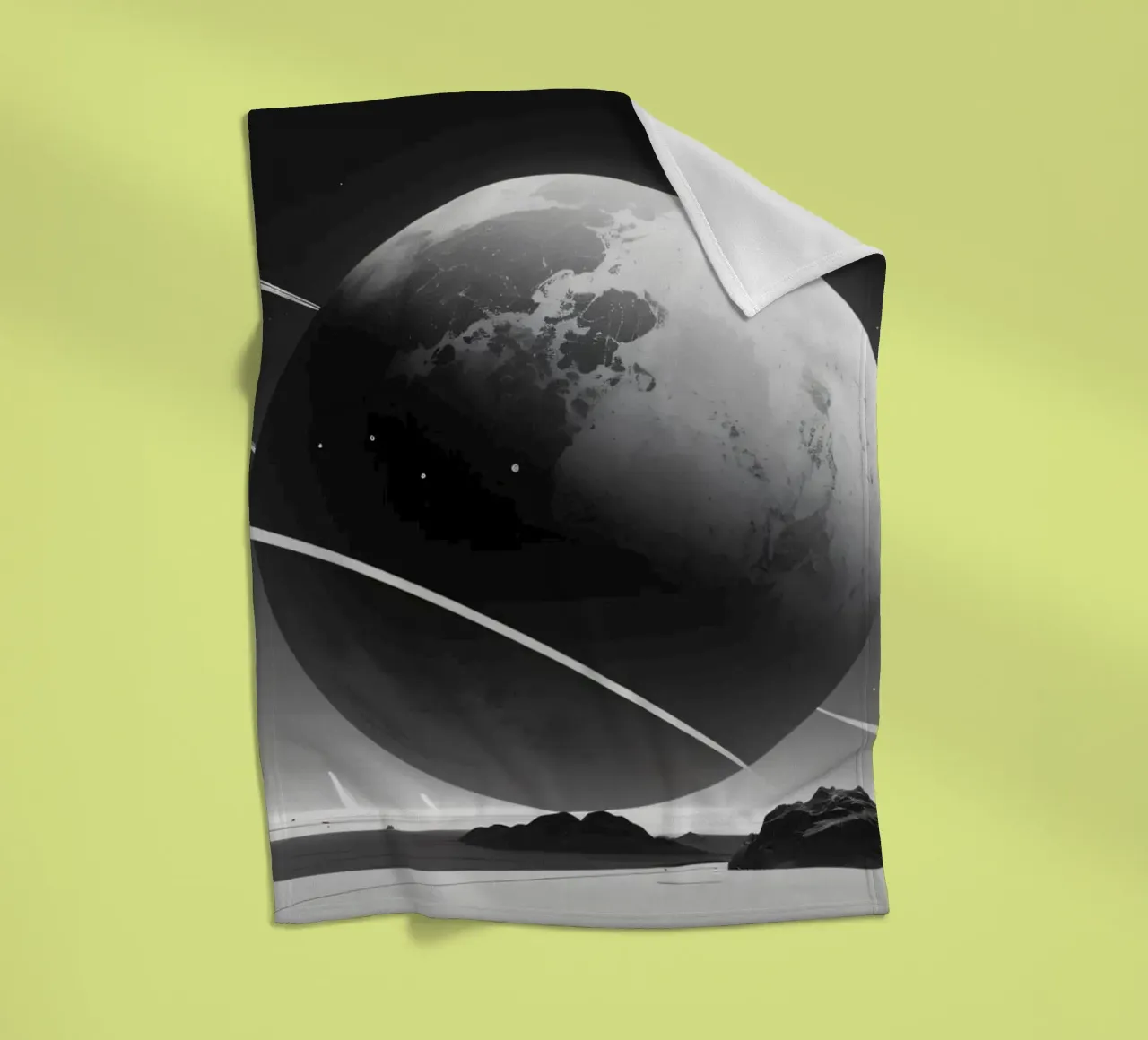 planet with rings hovering over a desolate landscape under a fleece blanket by DesignDoodle
