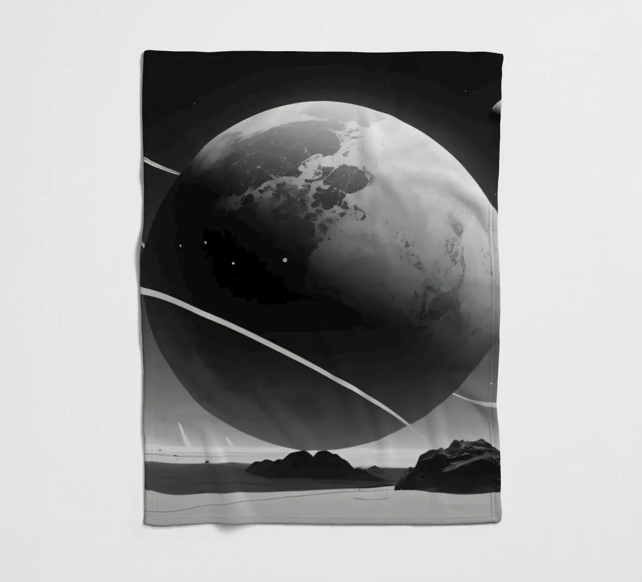 planet with rings hovering over a desolate landscape under a fleece blanket by DesignDoodle