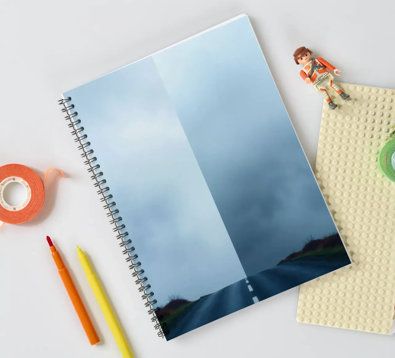 road leads into foggy distance with greenery on both sides spiral notebook by DesignDoodle