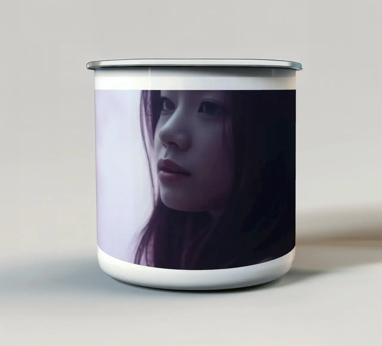 Una giovane donna guarda pensierosa in una foresta nebbiosa di colore viola, mentre tazza in smalto da DesignDoodle