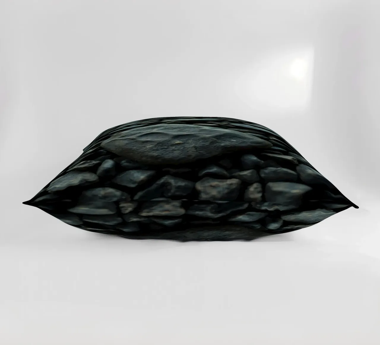 Pietre scure sparse su una spiaggia al tramonto cuscino da DesignDoodle