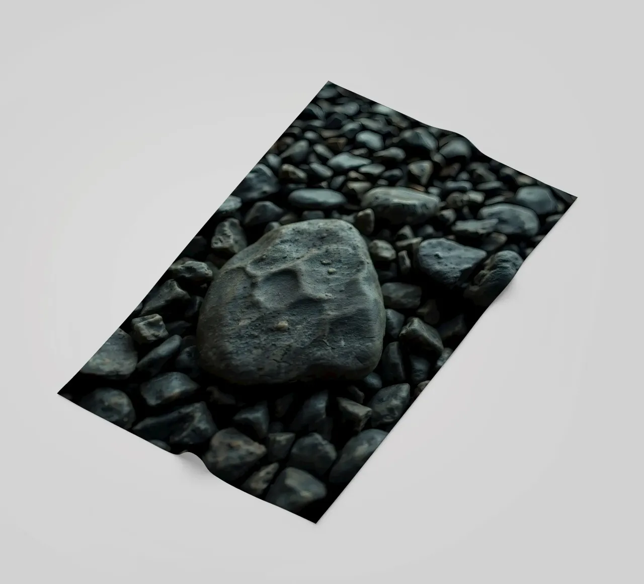 Pietre scure sparse su una spiaggia al tramonto telo mare da DesignDoodle